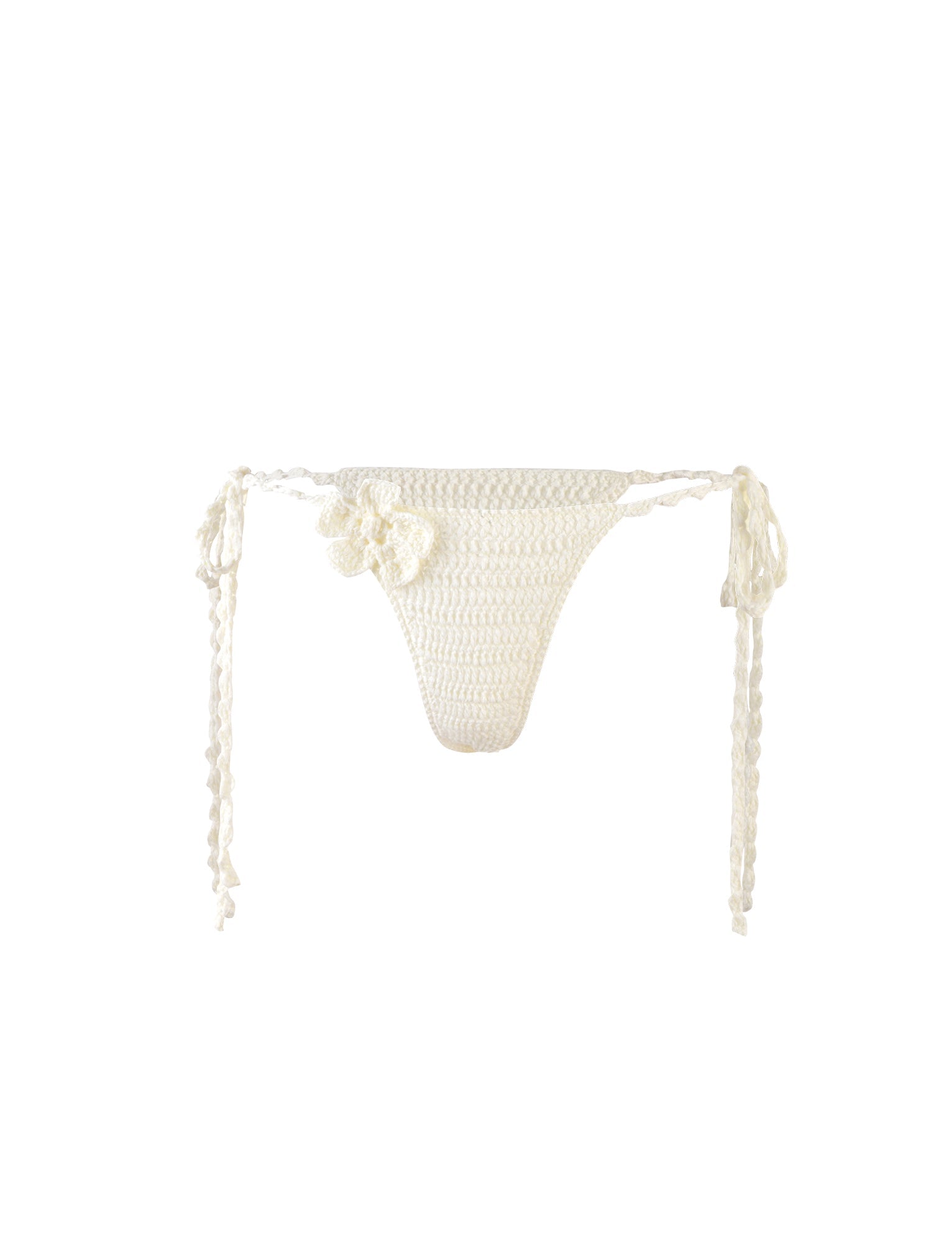 The MELIORA BIKINI BOTTOM - WHITE from TIGERMIST is a white, crocheted bikini bottom featuring side ties and a decorative crocheted flower detail on the left side. The textured, handmade fabric creates a delicate and summery look against the plain white background.