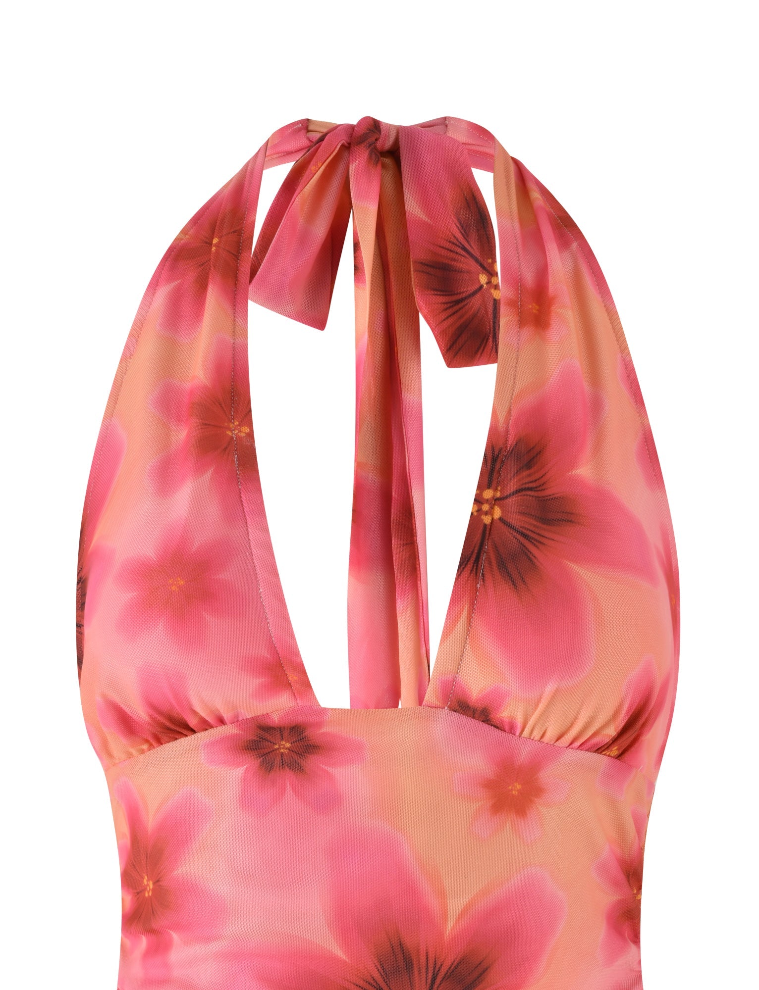 Close-up of the FRANCIS TOP - MULTI : OMBRE : FLORAL by TIGERMIST, showcasing a colorful floral pattern with large pink flowers set against a peach background. This halter neck design features wide straps that tie at the back and converge into a deep V-neckline. Crafted from lightweight mesh fabrication, it ensures a breezy and summery feel.
