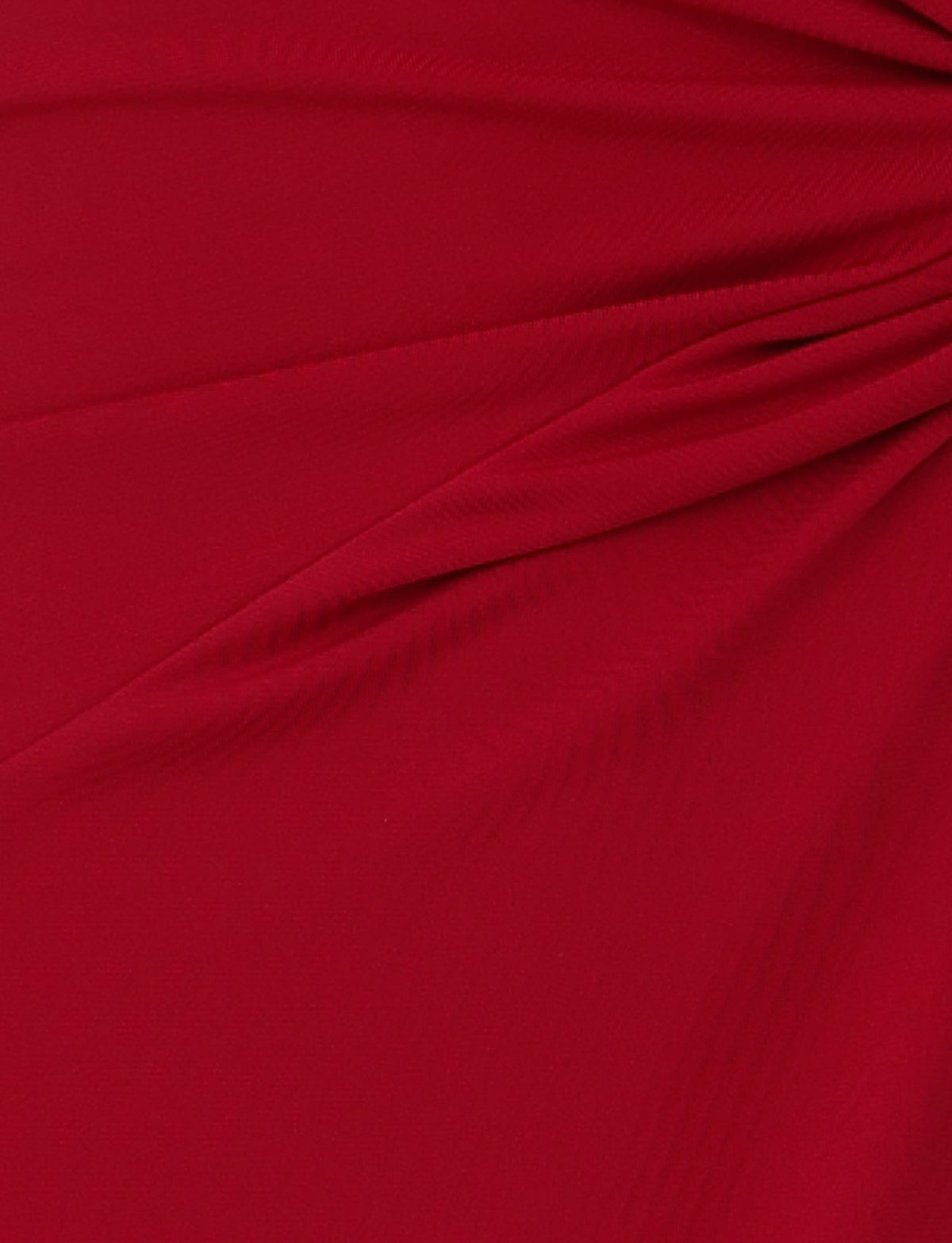 Close-up of the PARRIS DRESS - RED by TIGERMIST, showcasing its rich, vibrant color with subtle draping and folds reminiscent of a red halter neck dress. The fabric appears to be gathered slightly, creating a series of soft pleats and a textured surface.