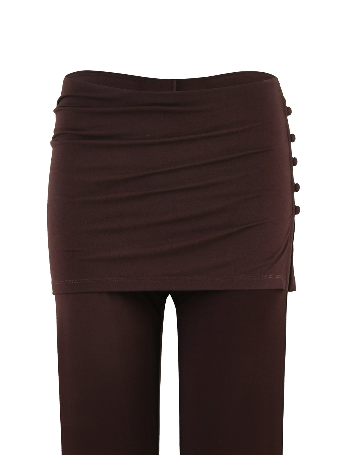 The LEILANI PANT - BROWN : CHOCOLATE by TIGERMIST showcases a ruched mini skirt overlay alongside decorative buttons on one side, with a flared leg design crafted from high stretch fabric. These pants are photographed against a plain white background.