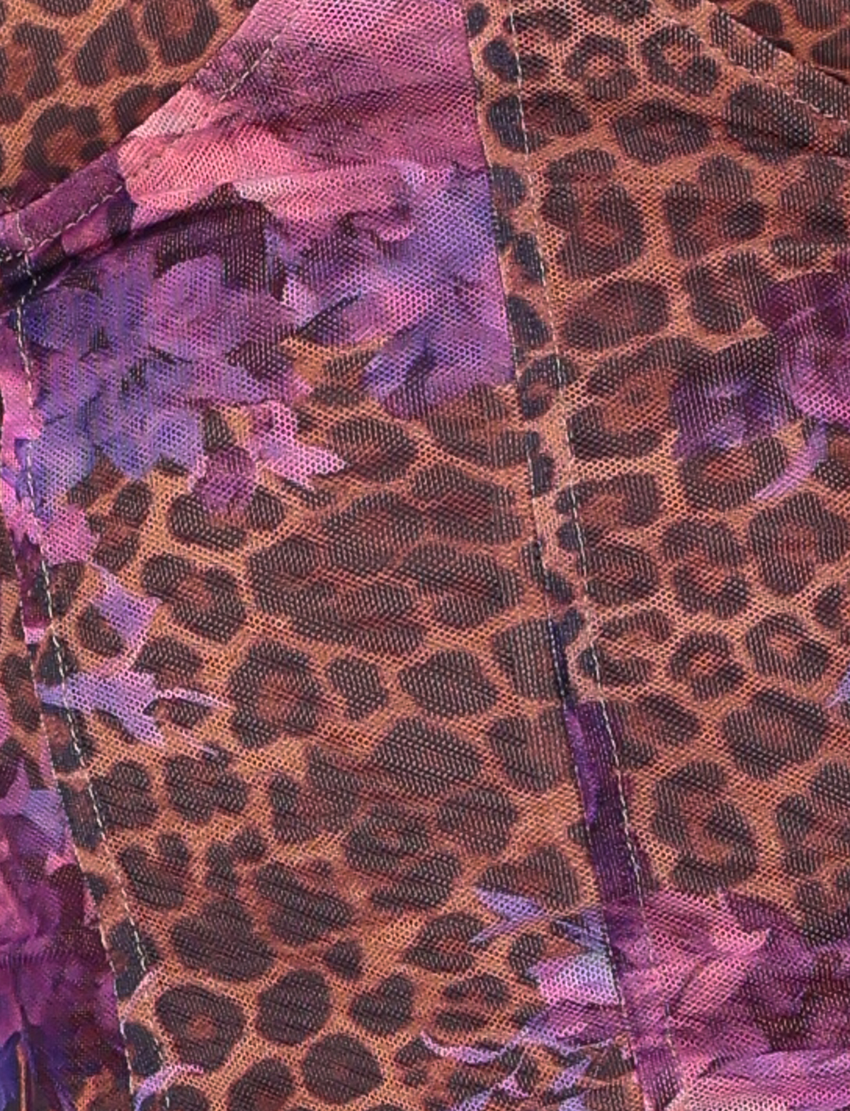 Close-up of the TIGERMIST HOLLIS TOP in FLORAL LEOPARD, featuring brown and black leopard print with purple and pink accents, visible stitching, and subtle touches of floral pattern.