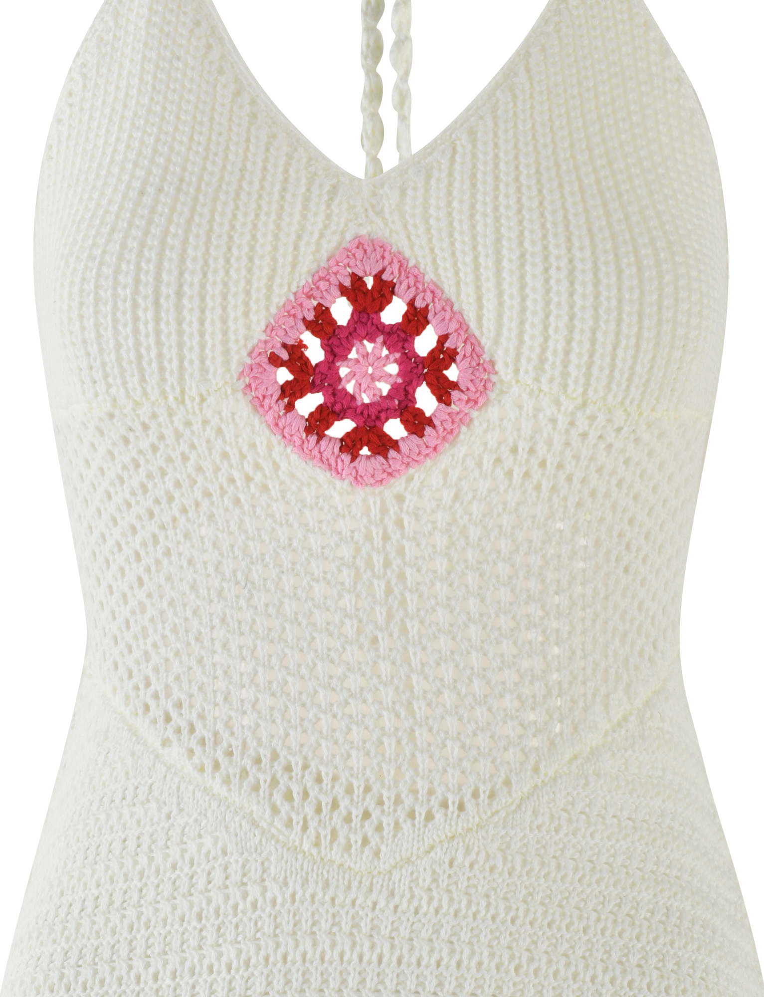 Close-up of the TENZIN MINI DRESS - CREAM by TIGERMIST, a white crochet mini dress with a halter neck and pink and red Granny Square detail at the center of the chest.