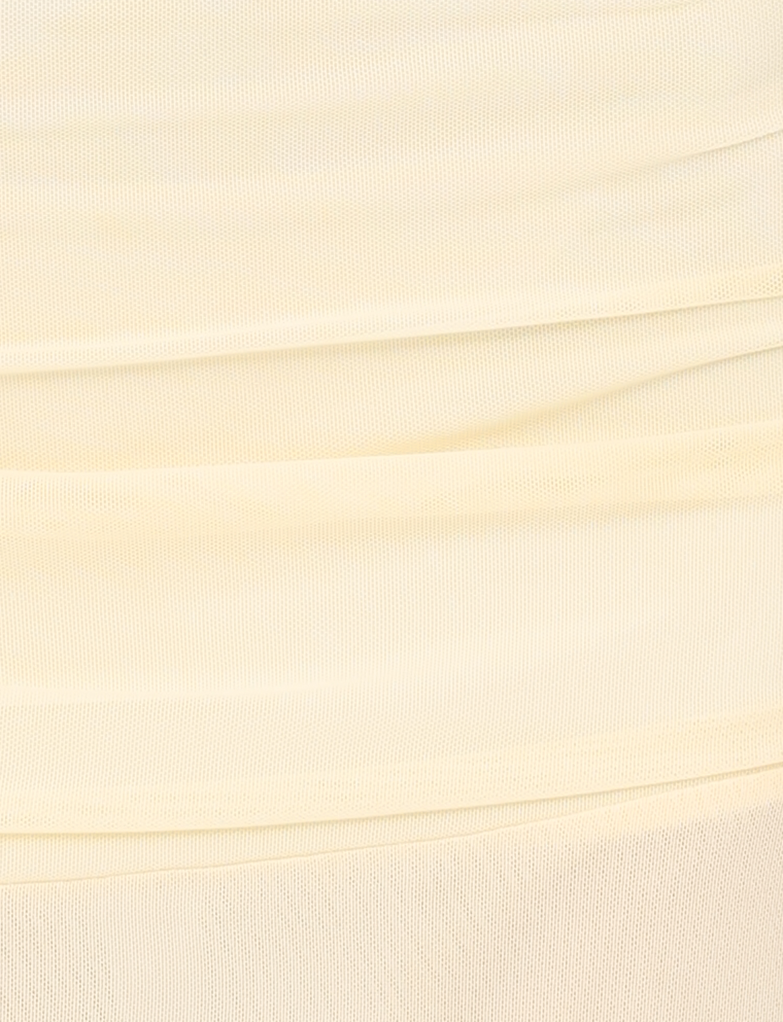 Close-up of the MARIANA SKIRT in pale yellow by TIGERMIST, featuring soft, high-stretch fabric with a textured mesh-like pattern and gentle horizontal folds.