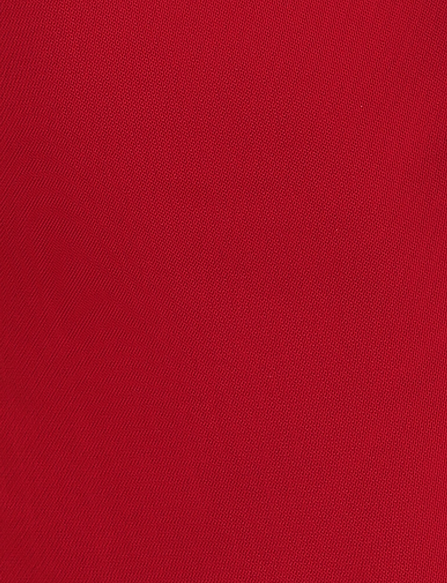 A close-up of the TIGERMIST NYOMI MINI DRESS - RED shows its red textured fabric, featuring fine diagonal lines and a subtle weave pattern.