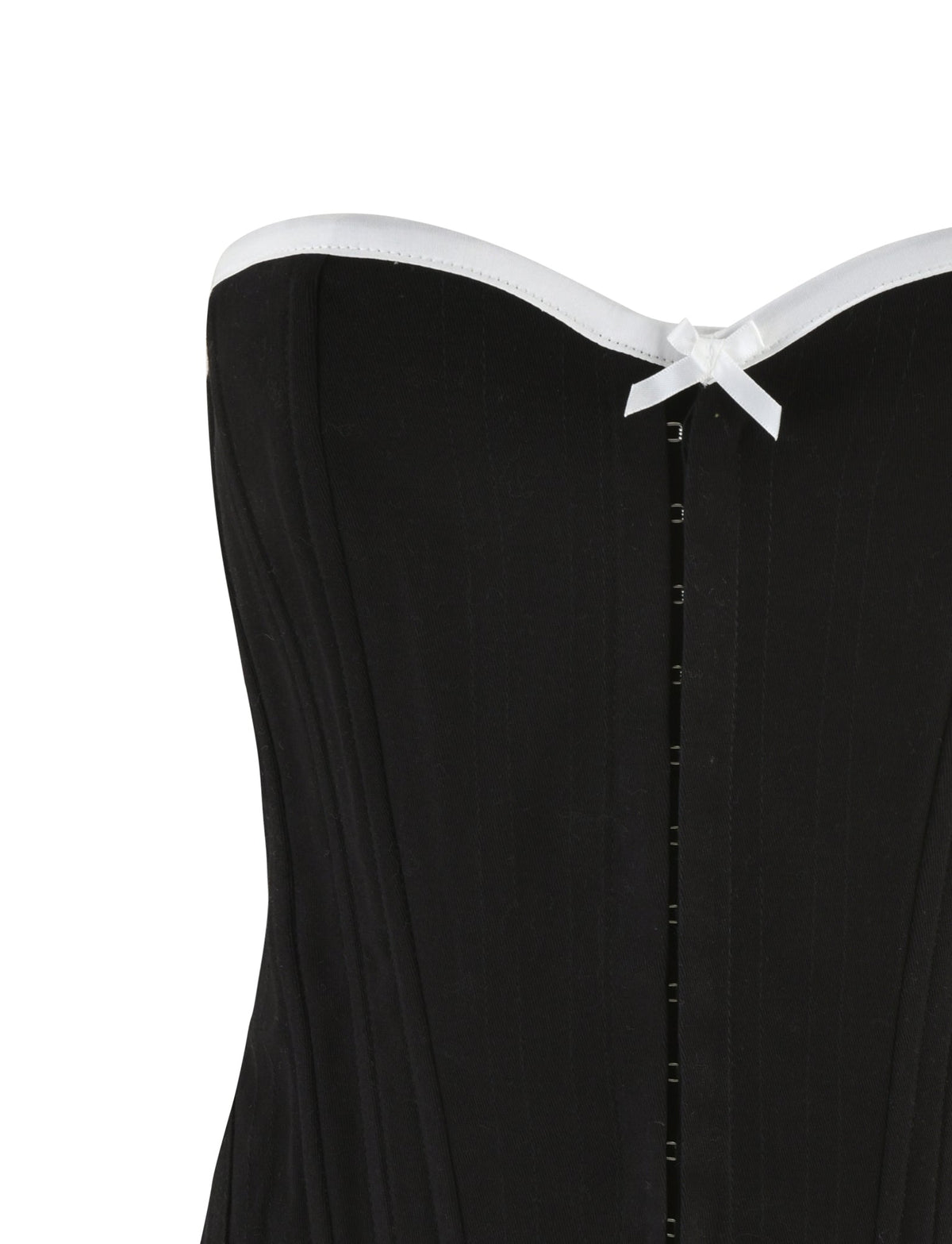 Close-up view of the TIGERMIST MILLIE CORSET 2.0 - BLACK, a strapless black denim corset with white ribbon trim along the top edge. The bodycon fit features vertical boning for structure and a row of hook-and-eye closures down the center front, with a small white decorative bow placed in the middle at the top.