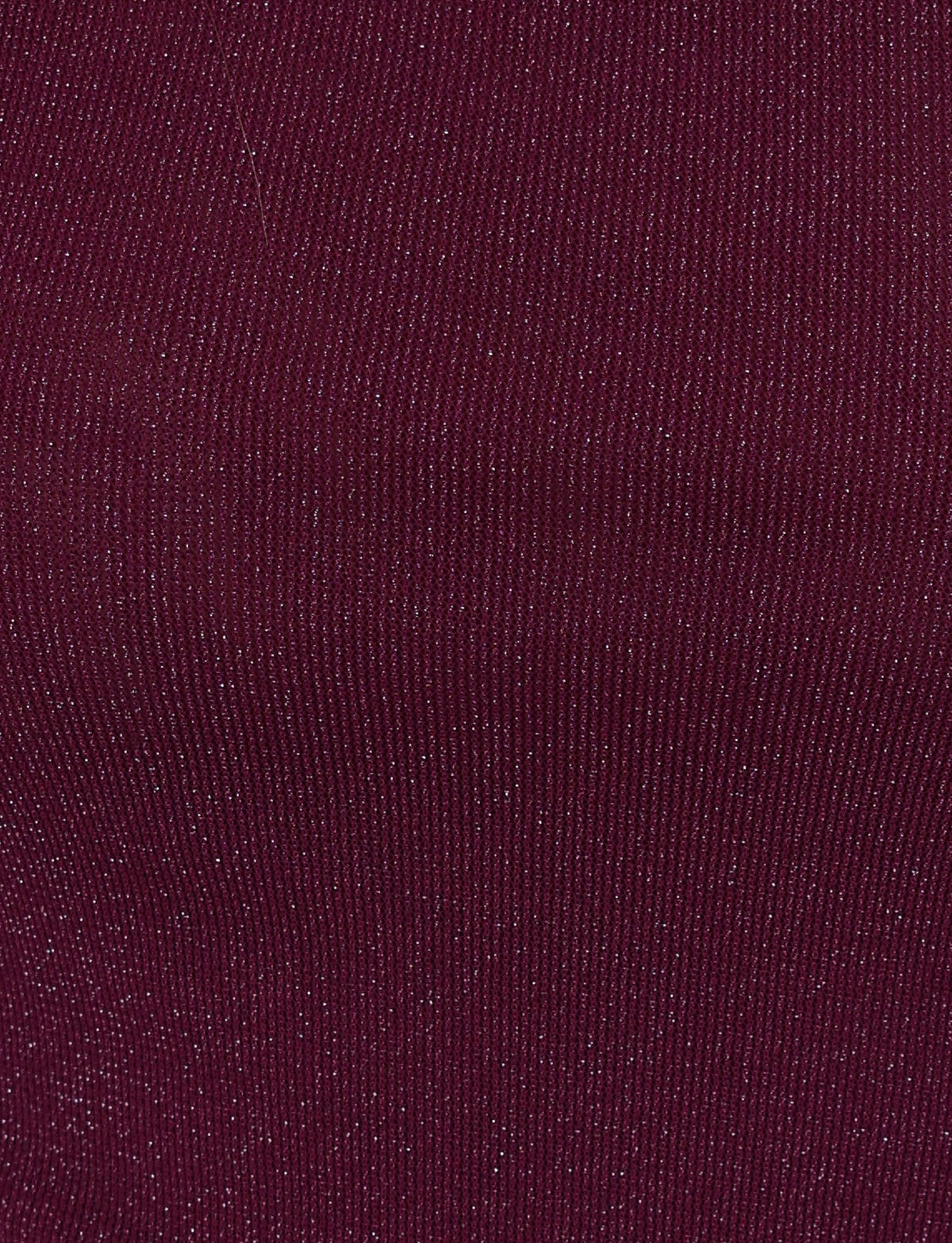 A close-up of the COBI MINI DRESS 2.0 - PURPLE by TIGERMIST showcases its textured fabric in a rich, dark maroon hue, featuring fine vertical lines and subtle sparkling details that evoke the shimmering effect of a glitter dress.