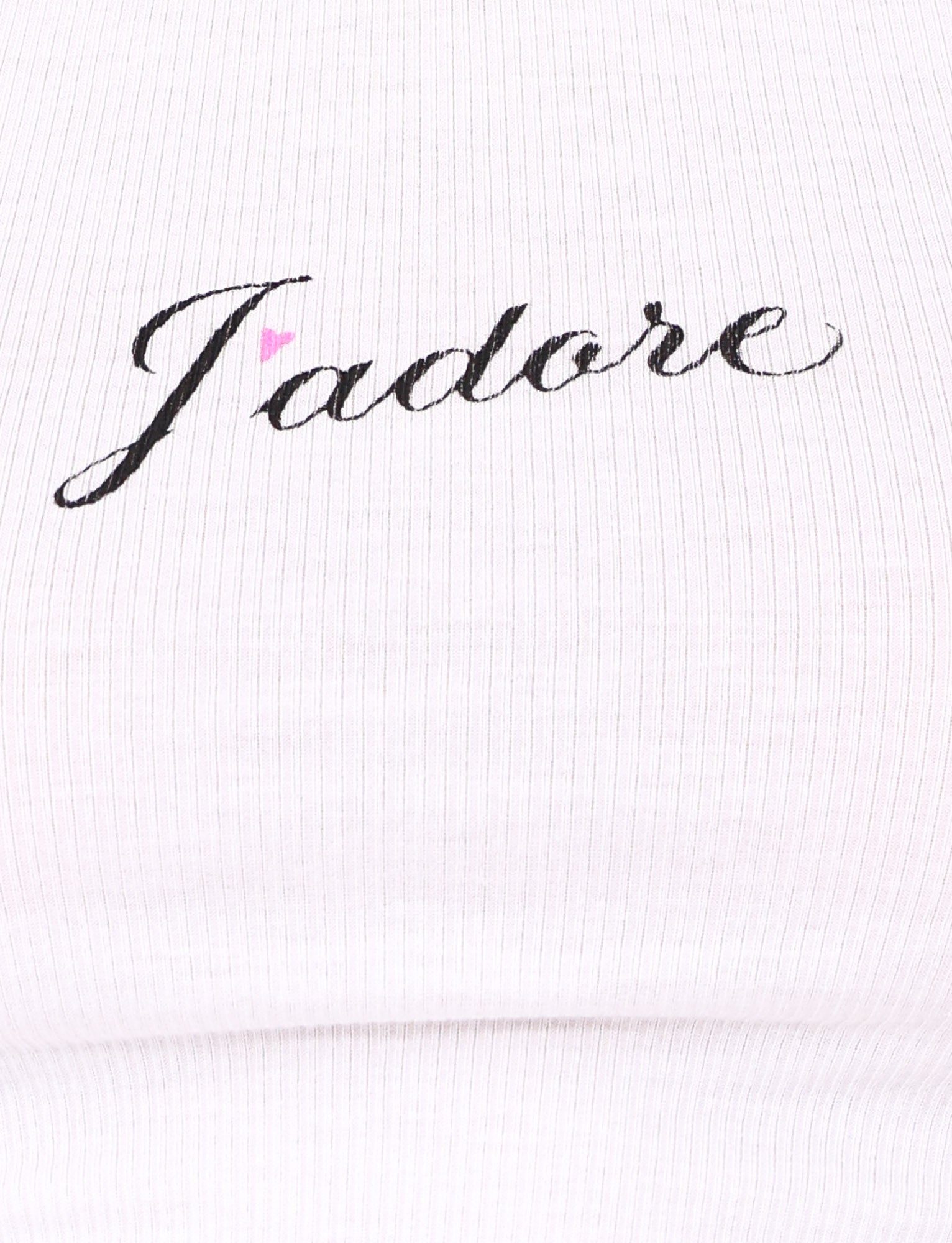 Close-up of ribbed fabric on the TIGERMIST RAFAELLA TANK in white, featuring a black cursive "J'Adore" graphic with a small pink heart above the letter “a” on a racerback design.