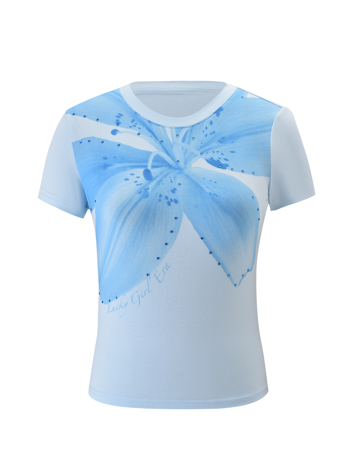 The SAPHIRA TEE - BLUE by TIGERMIST features a large floral graphic and "Lucky Girl Era" text on the front, crafted from soft, stretchy fabric for all-day comfort.