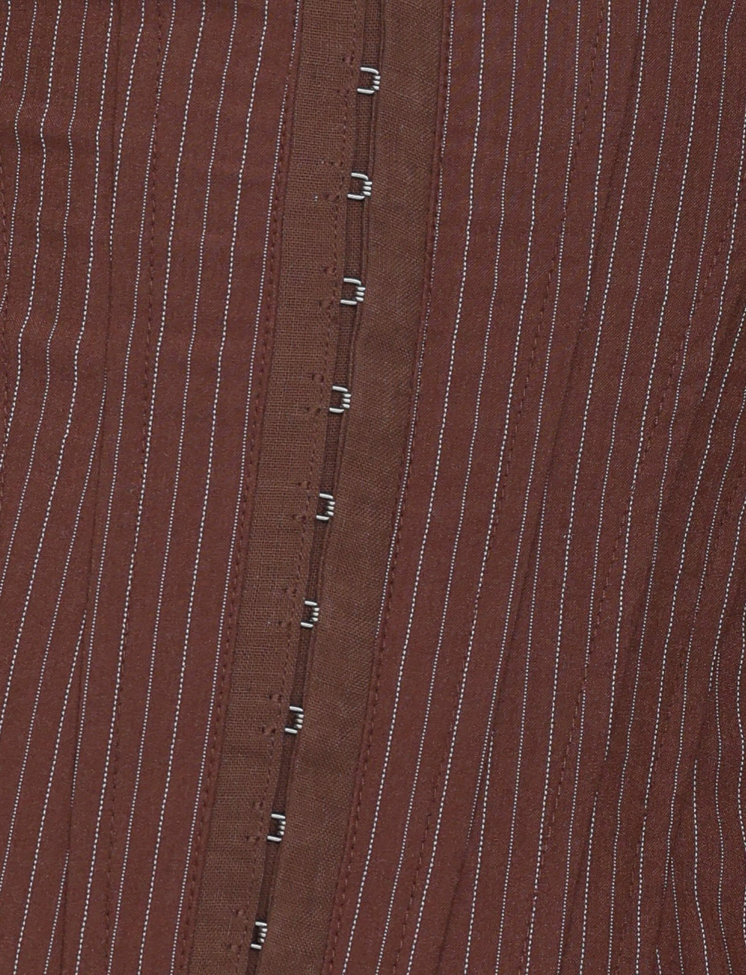 Close-up of the TIGERMIST ANTONELLA CORSET 2.0 in chocolate pinstripe, featuring high quality suiting fabric with white vertical stripes and metal hook-and-eye closures down the center.