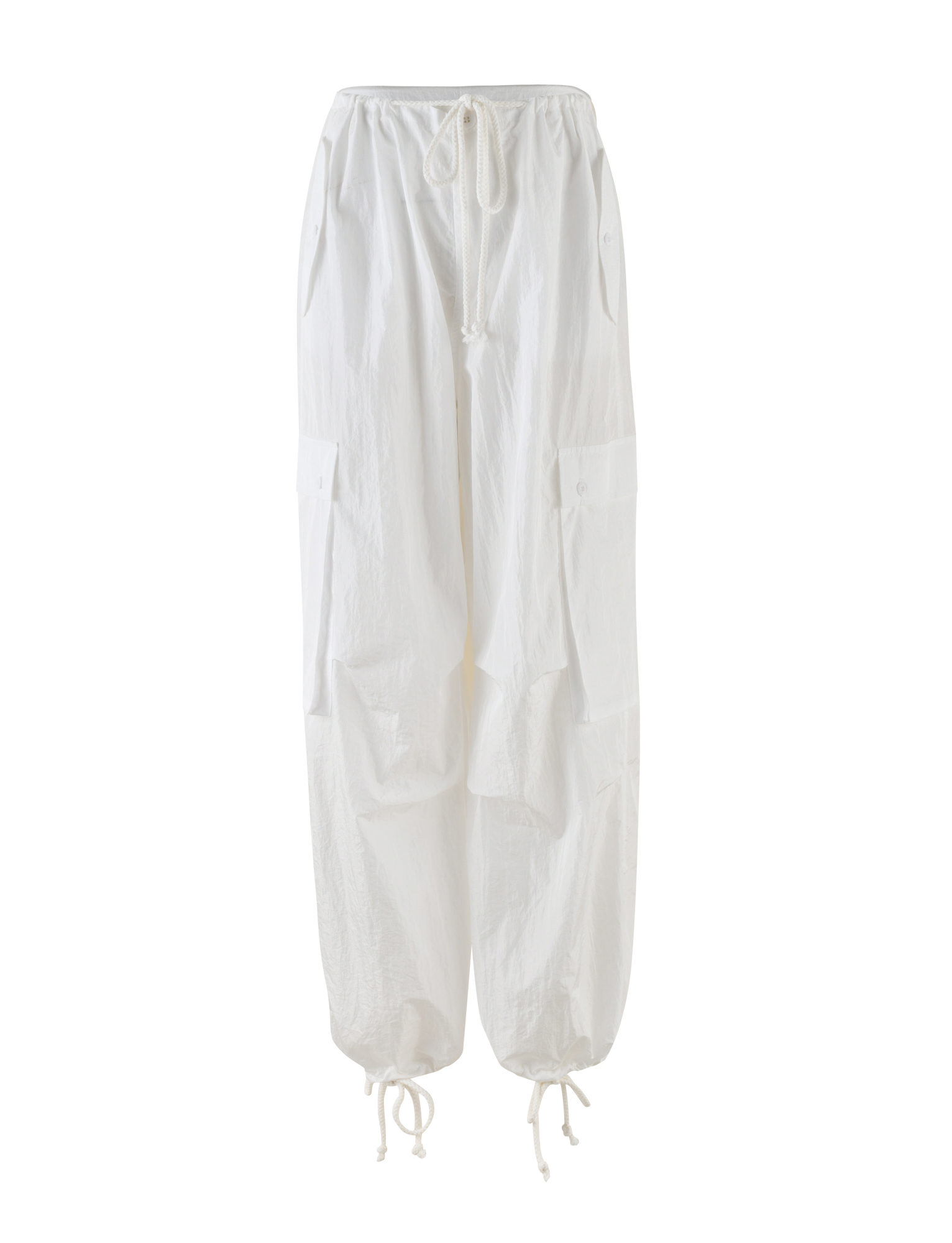 The VIOLETTE PANT in white by TIGERMIST features a baggy fit with large side pockets, adjustable waist, ankle ties, and a relaxed crinkled texture, showcased on a plain white background.