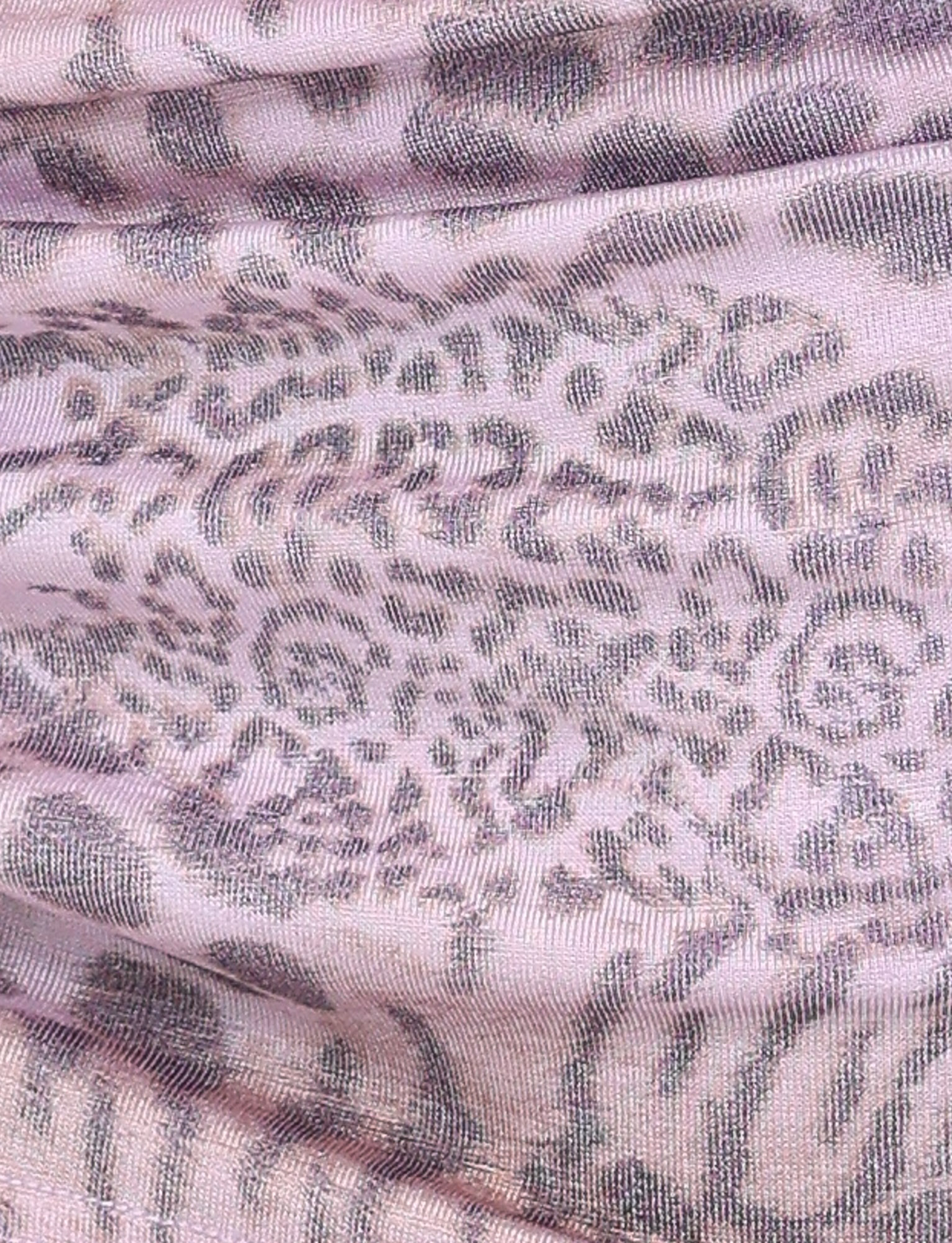 Close-up of the EVANGELINE SKIRT - PINK from TIGERMIST, showcasing its pale pink tiger print with abstract wavy lines and organic shapes for a textured look.