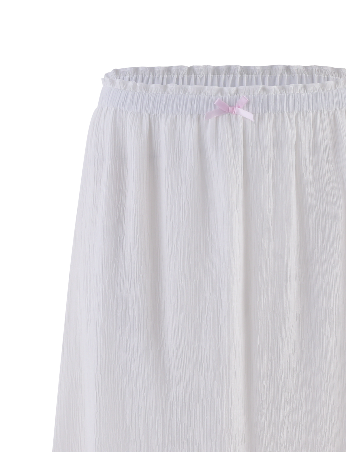 A close-up of the TIGERMIST ASHLYNN MAXI SKIRT in white, featuring textured fabric, an elastic waist, and a small satin bow trim at the center.