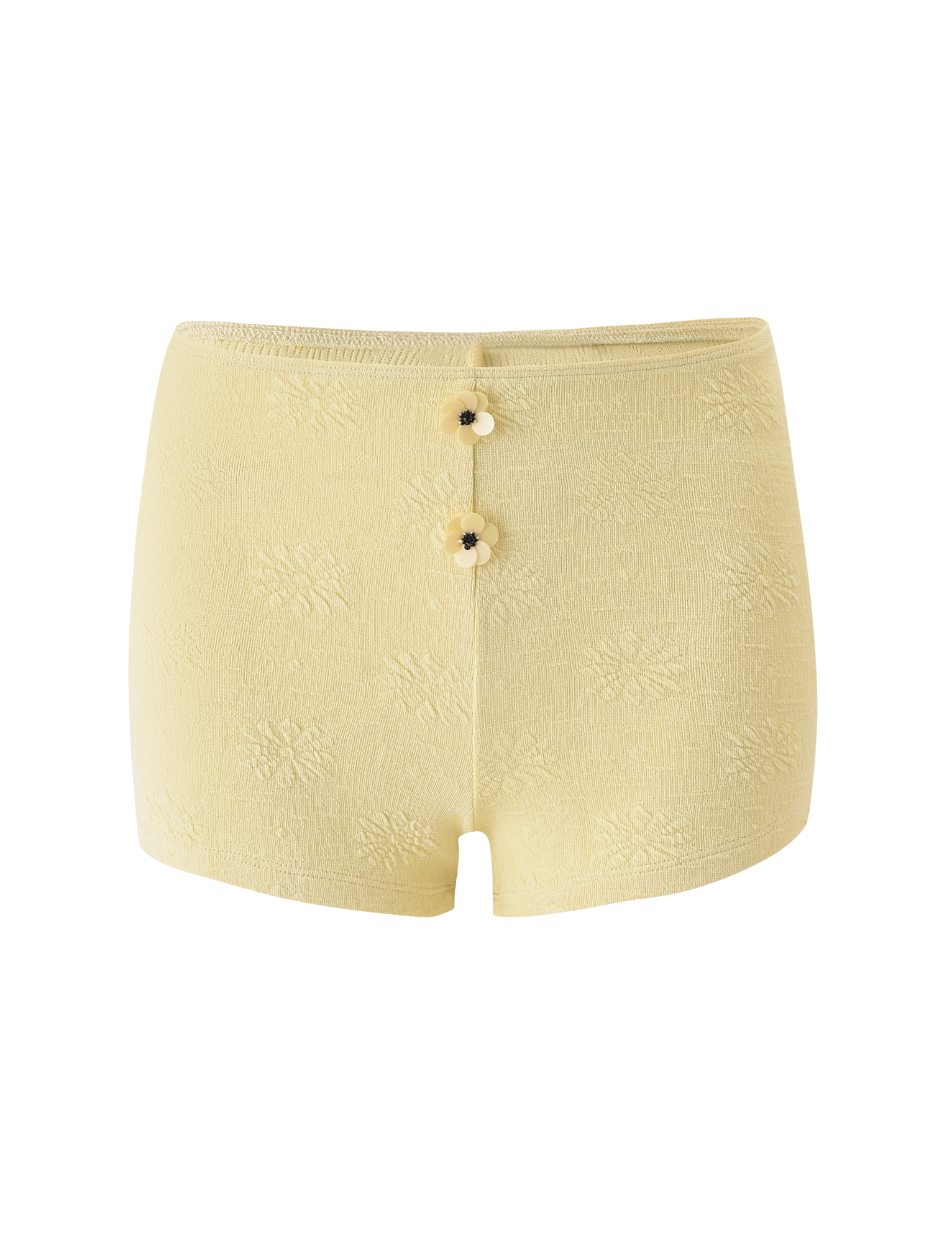The QUINLAN SHORT - LEMON by TIGERMIST features a high-waisted fit, subtle floral pattern, delicate flower details, and two round buttons on the front. Displayed against a white background.