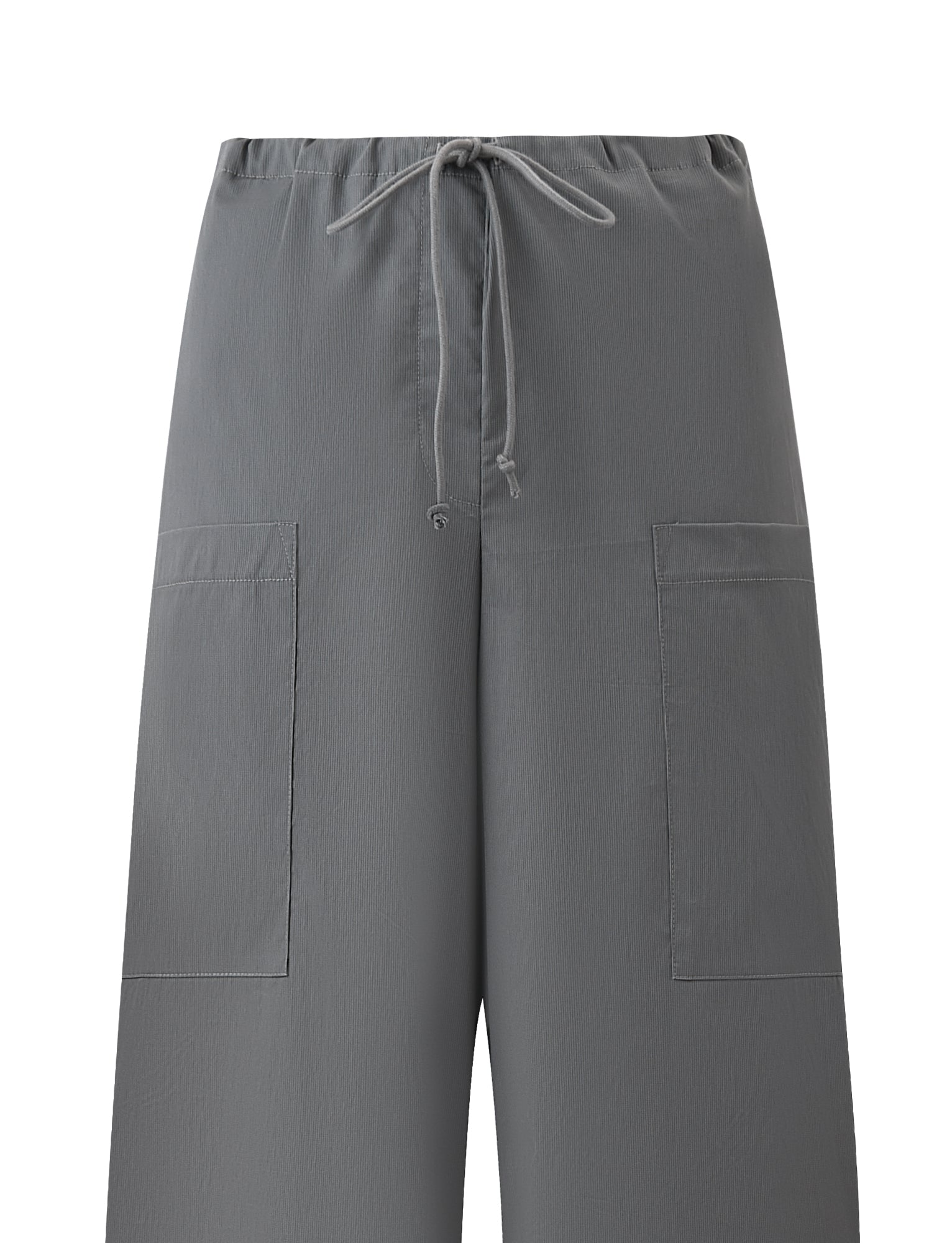 The TYSHA PANT - CHARCOAL by TIGERMIST features wide-leg styling, an elastic drawstring waist, and two large square front pockets. These lightweight charcoal cargo pants are displayed against a white background.