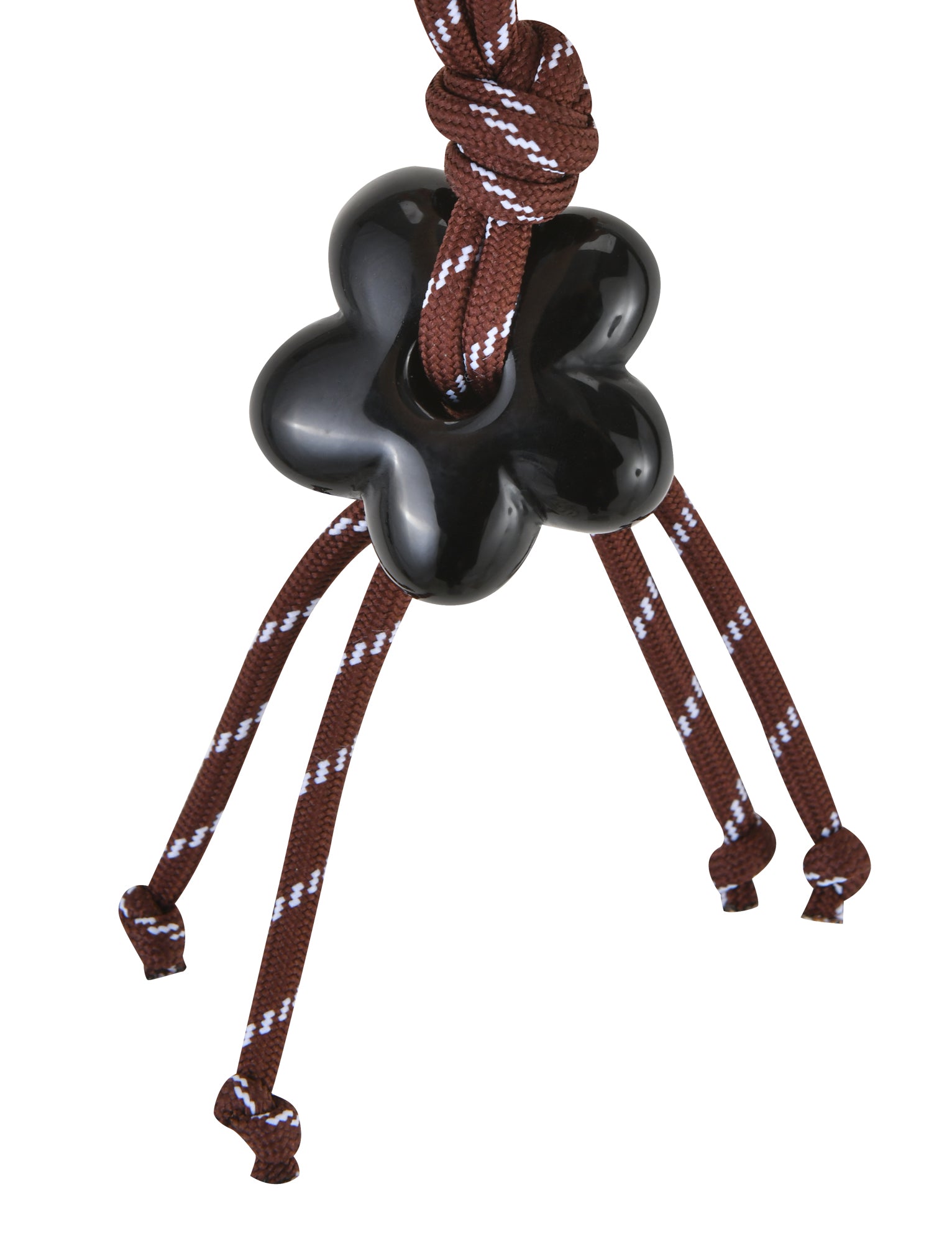 TIGERMIST's MIRIAM KEYCHAIN - CHOCOLATE features a black, flower-shaped charm with brown and white braided cords. The cords are tied into four loose knots, showcasing a decorative design. A glossy finish highlights the pendant, paired with a sleek metal heart clasp for added elegance.
