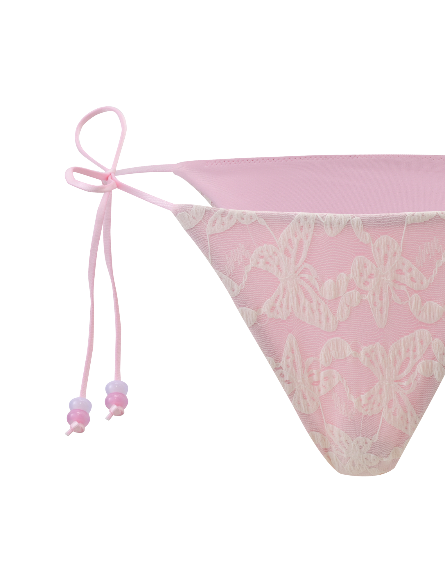 A close-up of the TIGERMIST BRIGITTE BIKINI BOTTOM in ivory lace, featuring a cheeky fit with thin side ties and delicate lace overlay, shown against a light background.