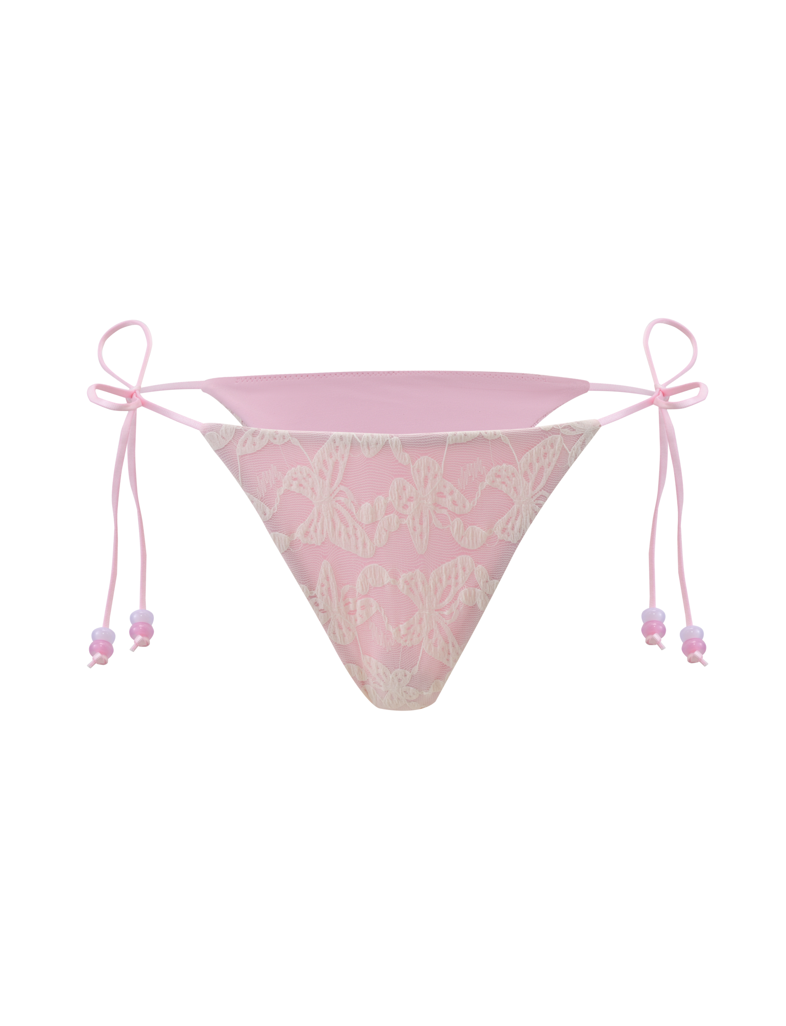 The TIGERMIST BRIGITTE BIKINI BOTTOM in ivory lace features white butterfly patterns, pink ribbon side ties, and a cheeky bikini cut, shown against a pale pink background.