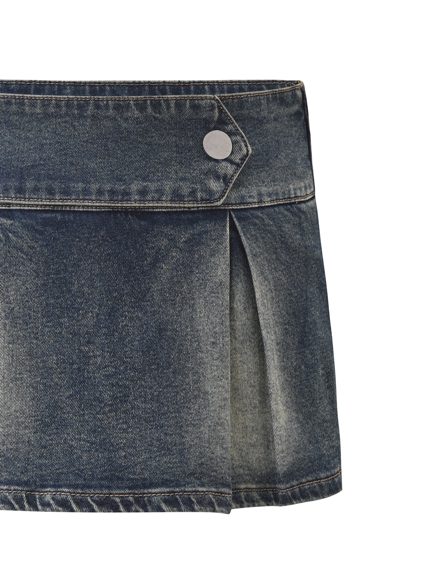 A close-up of the TIGERMIST LUPITA SKORT - MID WASH, a blue pleated denim mini skort with a wide waistband, contrast stitching, silver button flap detail at the waist, and front pleats on a white background.