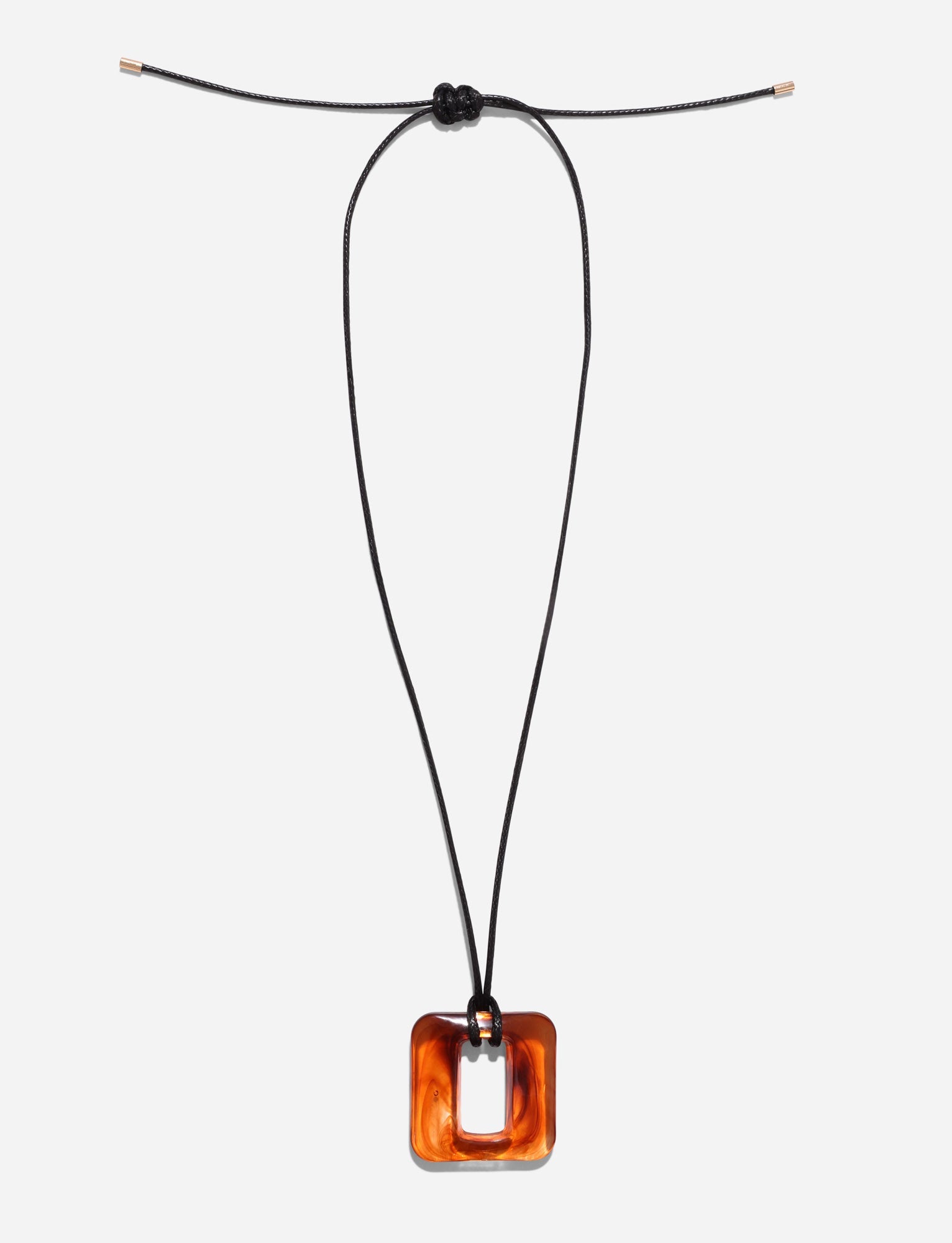 The MIRREN SQUARE NECKLACE - BROWN by TIGERMIST elegantly displays a square tortoiseshell resin pendant on an adjustable black cord against a white backdrop.