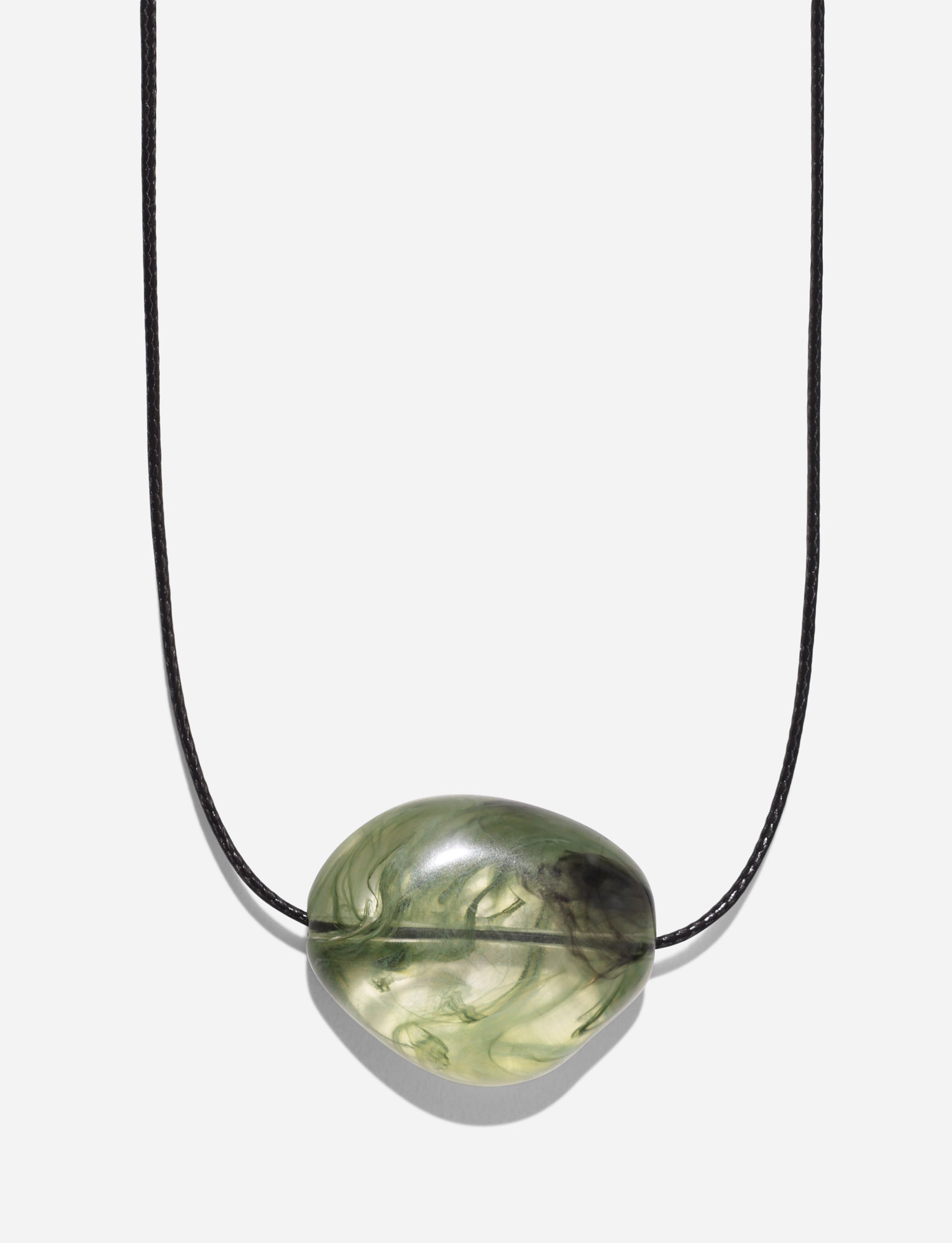 The TIGERMIST SOLENE NECKLACE - GREEN features a black woven cord and a single smooth, oval green stone with swirled patterns, showcased on a plain white background.