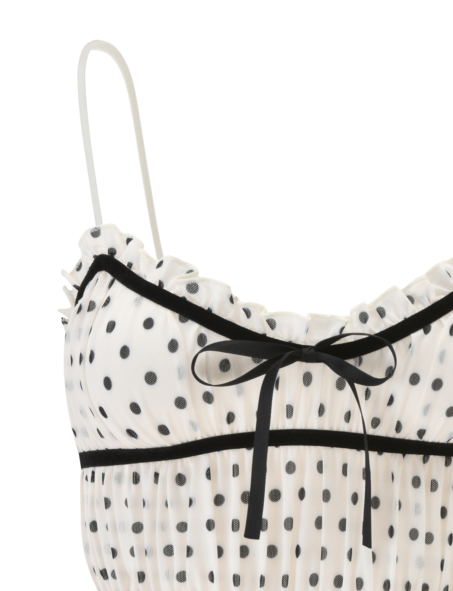 The LIORA TOP - POLKA DOT by TIGERMIST features a white polka dot cami with black trim, a small bow at the neckline, sheer fabric, ruffled top edge, and adjustable straps for the perfect fit.