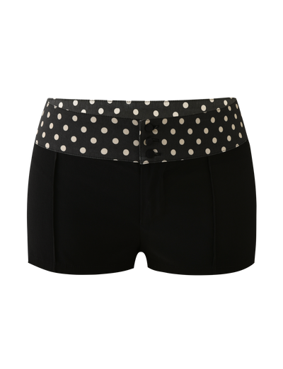 The KITTIE 2.0 SHORT - BLACK by TIGERMIST features a high polka dot waistband, black Kittie fabric, and decorative black front buttons. Displayed on a plain white background.