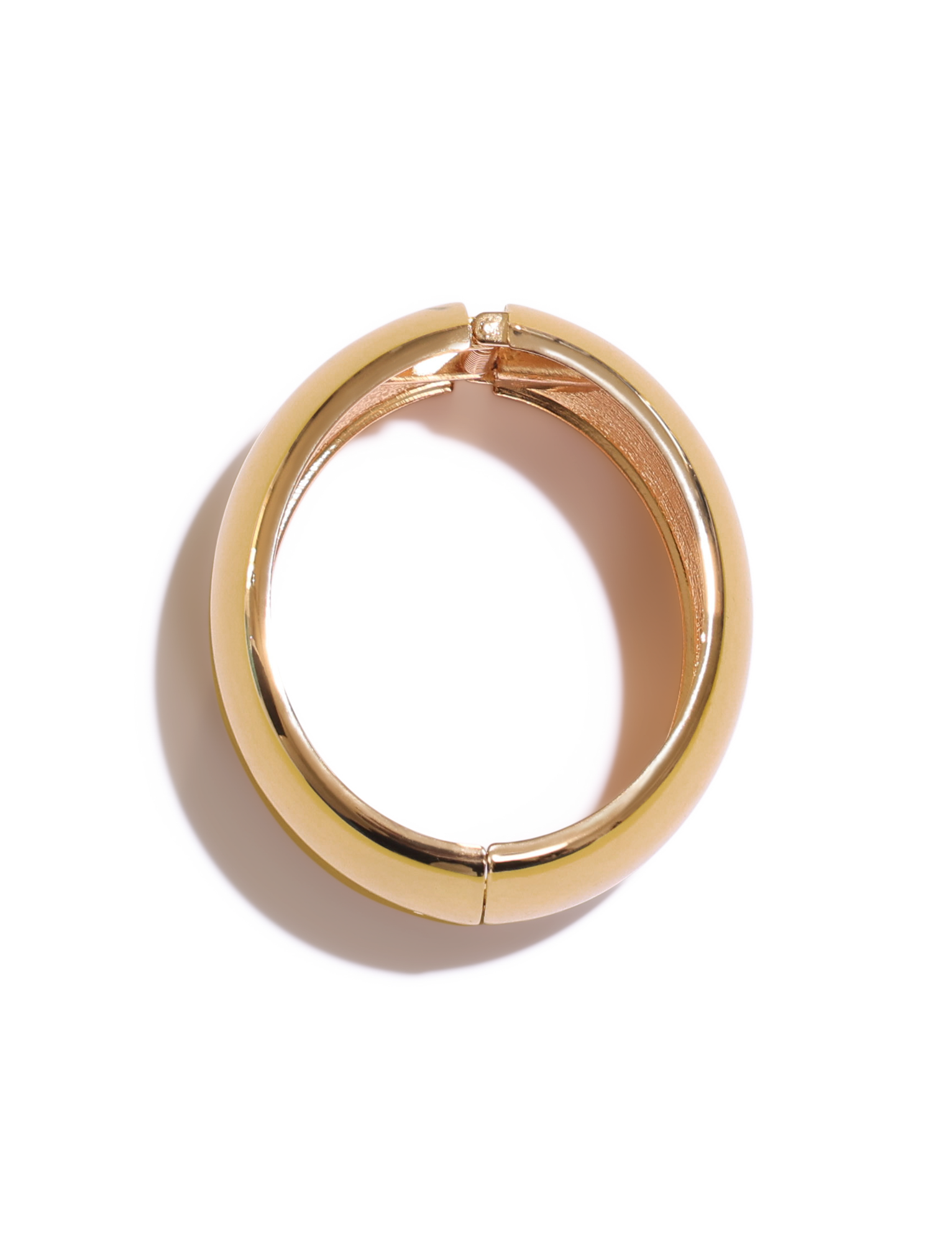 A single gold hoop earring with a hinged clasp is displayed on white, pairing perfectly with the TIGERMIST MIRAH CHUNKY BANGLE - GOLD for an effortlessly chic look.