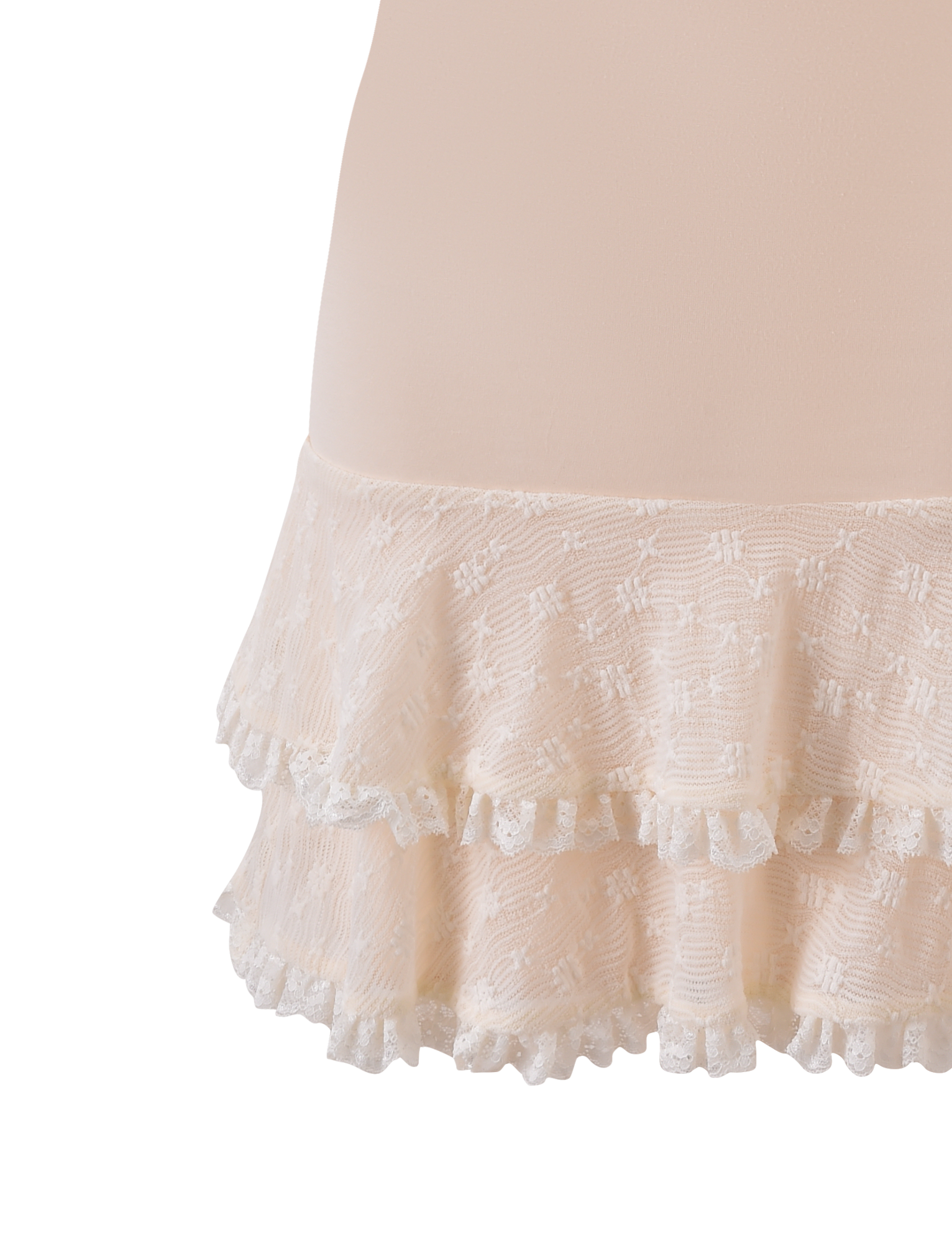 Close-up of the ANOUK RUFFLE MINI DRESS in cream by TIGERMIST, showcasing light pink sheer fabric with two ruffled lace tiers and a subtle floral pattern on the lower part of the dress.