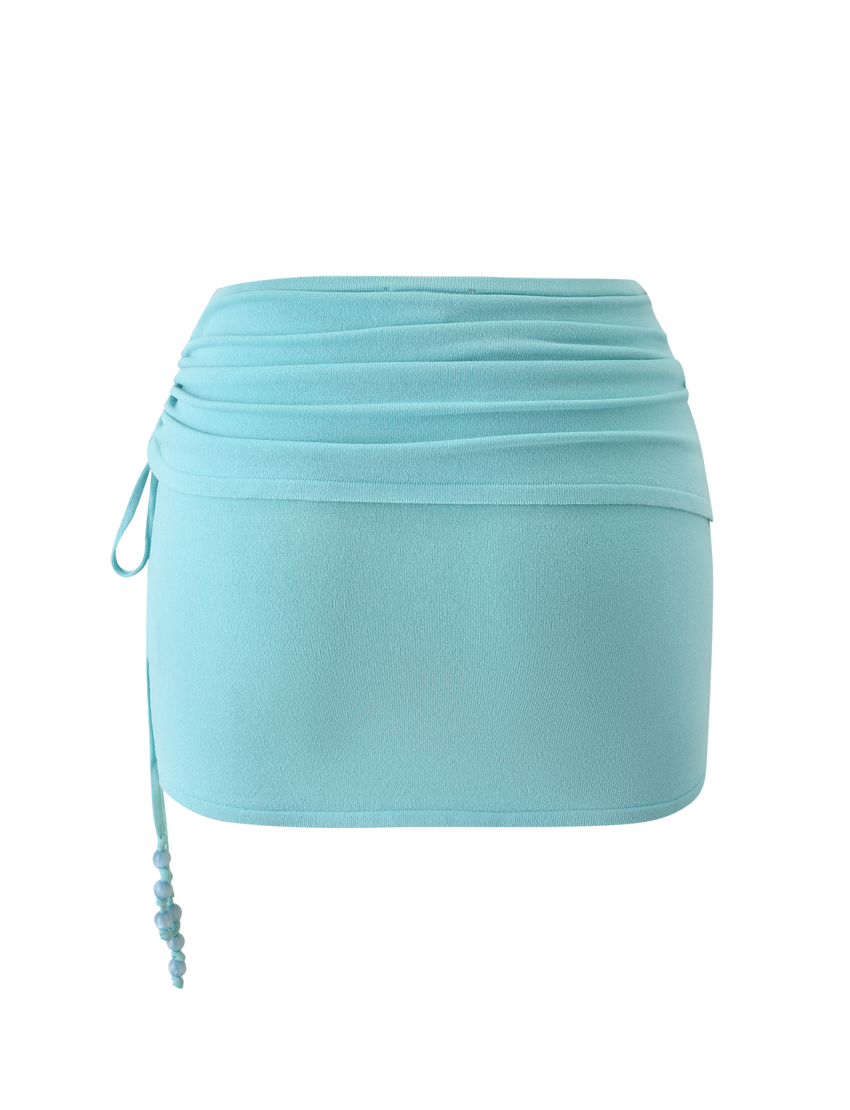 The JASMINA KNIT MINI SKIRT - BLUE by TIGERMIST features a light blue hue, ruched waistband, side drawstring with beaded detail, and a fitted silhouette for a smooth, effortlessly stylish look.