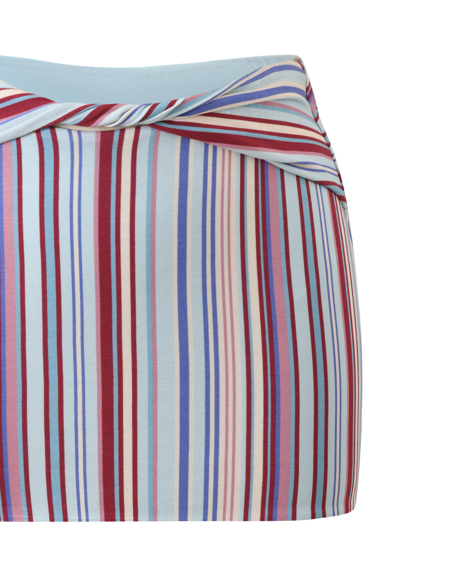 A close-up of the TIGERMIST HAZE TWIST SKIRT - VARIEGATED STRIPE, a fitted mini skirt featuring a diagonal waistband and vertical stripes in red, blue, white, and light pink on a light blue background.