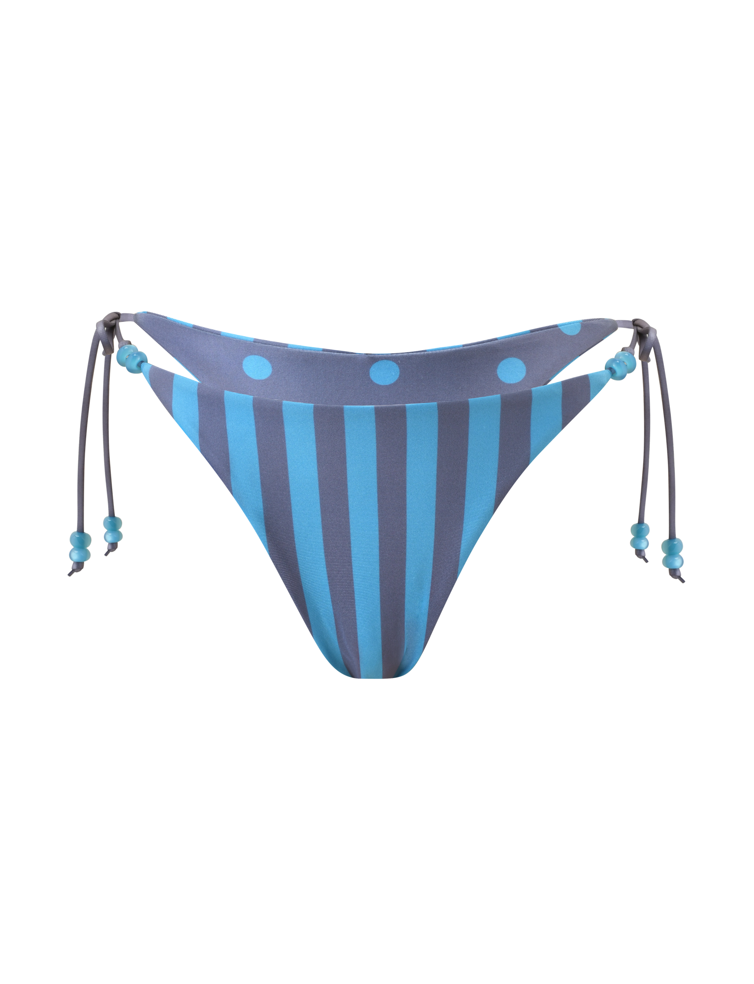 The FINLEA REVERSIBLE BIKINI BOTTOM by TIGERMIST features blue-grey vertical stripes with large polka dots at the top, a cheeky cut, and side ties with beaded details. Shown on a plain white background.