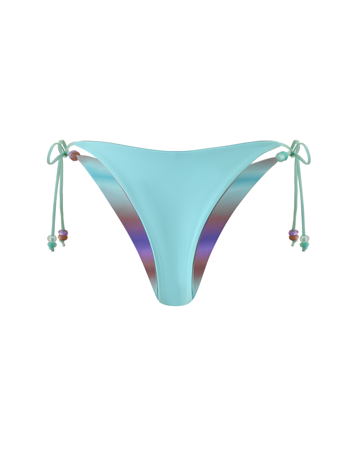 The TIGERMIST REVERSIBLE FINLEA BIKINI BOTTOM - MERMAID OMBRE STRIPE features a light blue hue with adjustable side tie closures adorned with beaded accents. Designed in a cheeky cut, these bikini bottoms are reversible, showcasing a striking purple-toned ombre stripe lining on the interior for versatile styling against a solid light gray background.