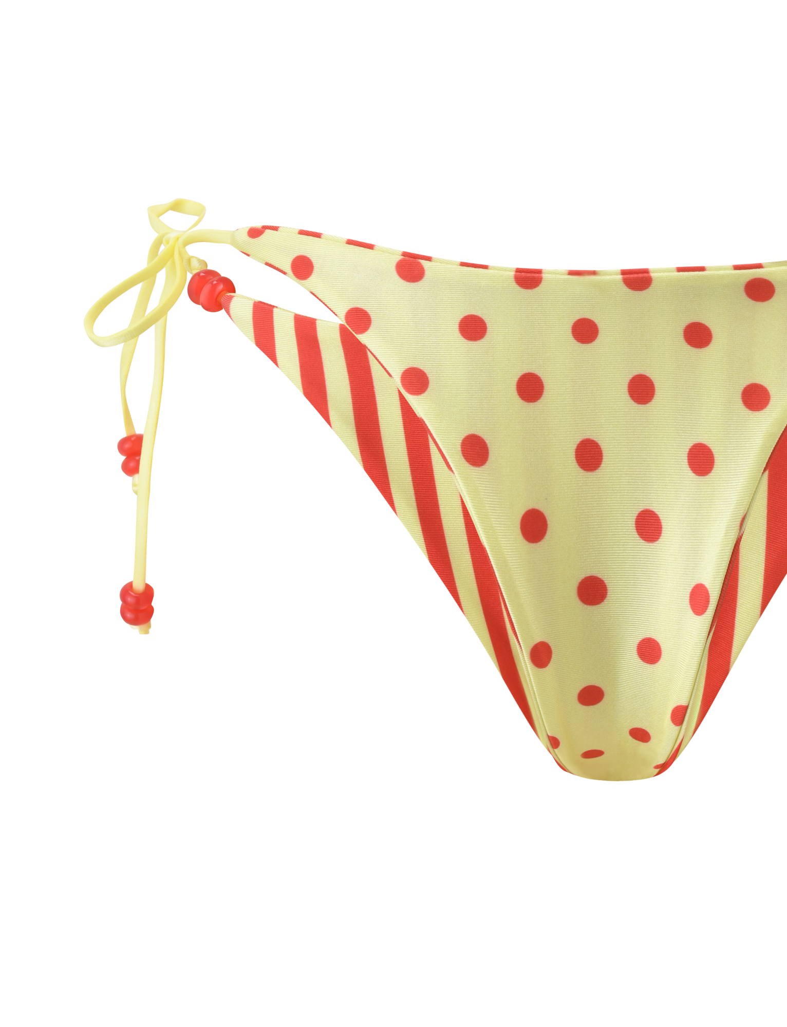 The FINLEA REVERSIBLE BIKINI BOTTOM by TIGERMIST features a cheeky cut, side ties with yellow strings and red bead accents, in a red-yellow dot and stripe design, shown on a white background.