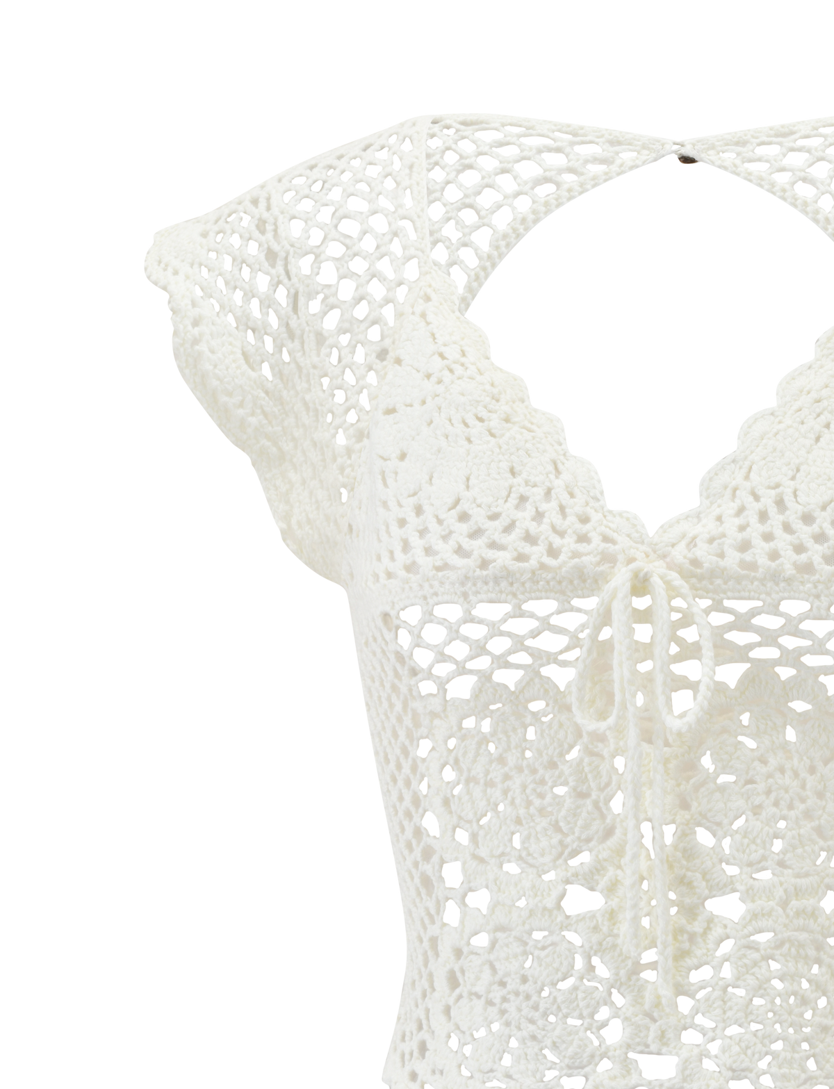 Close-up of the SASHA CROCHET TOP - IVORY by TIGERMIST, featuring scalloped cap sleeves, a V-neckline, corset-style front tie, and intricate floral and geometric crochet patterns.