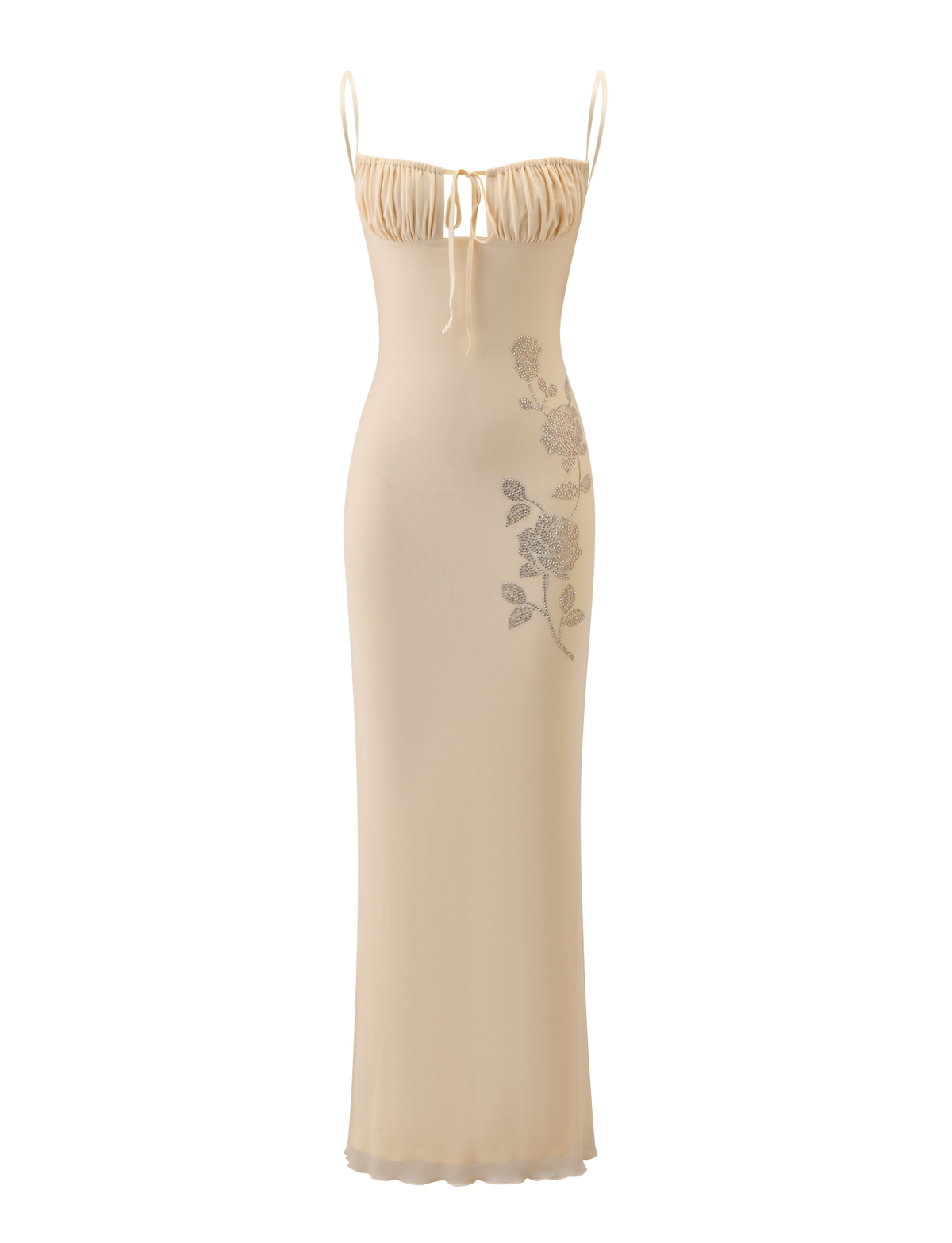 The OPHELIA MAXI DRESS by TIGERMIST features a cream hue, adjustable spaghetti straps, a gathered bust with a dainty bow, and delicate floral detailing along one side.