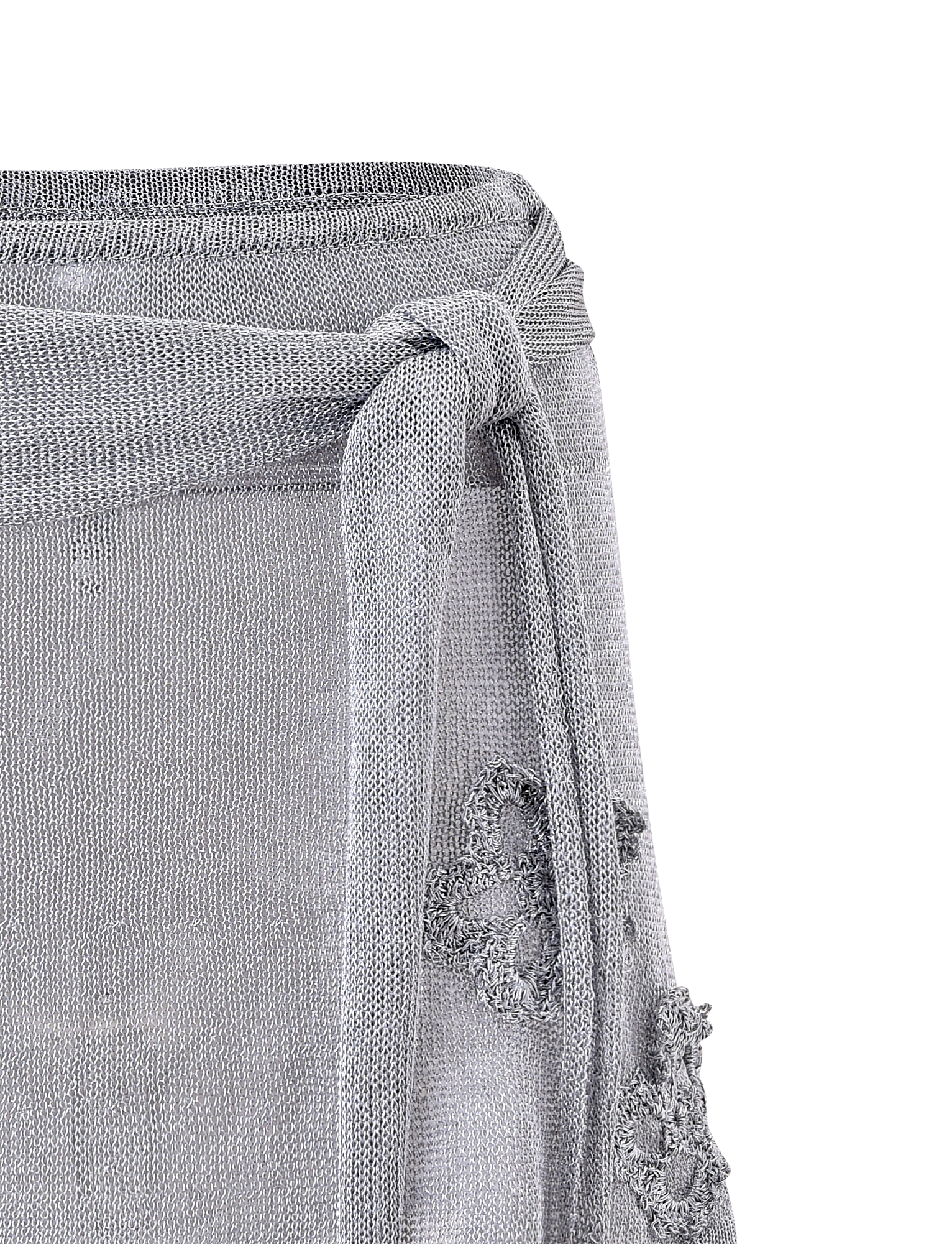 Close-up of the TIGERMIST ISATANA MINI SKIRT - SILVER, featuring light gray sheer metallic knit fabric, a textured waist tie bow, and decorative floral lace patterns on the side.