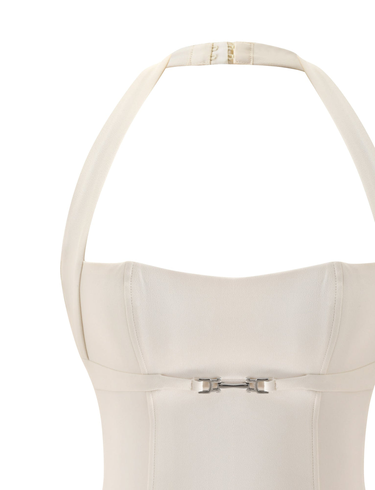 Close-up of the TIGERMIST KITTIE BUCKLE TOP in cream, styled as a halter neck dress. This top features a structured bodice and is accented by a small silver buckle detail at the front center—making it the perfect chic choice for a bridal shower.