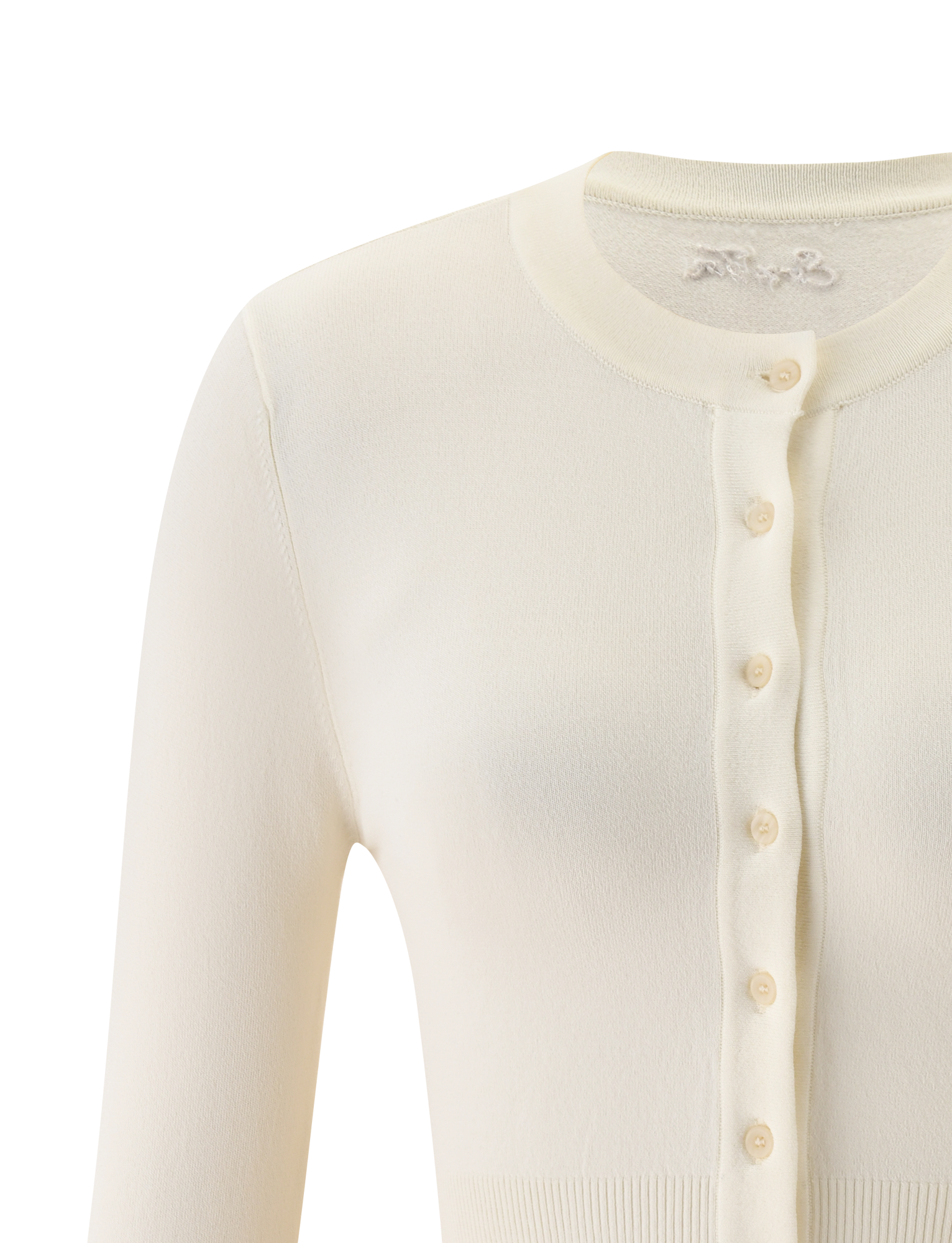 Close-up of the TIGERMIST DAMARIS CARDIGAN in cream, a knit button-up with a round neckline, ribbed hems and cuffs. The cropped silhouette’s upper half is visible, showcasing its soft, cozy fabric.