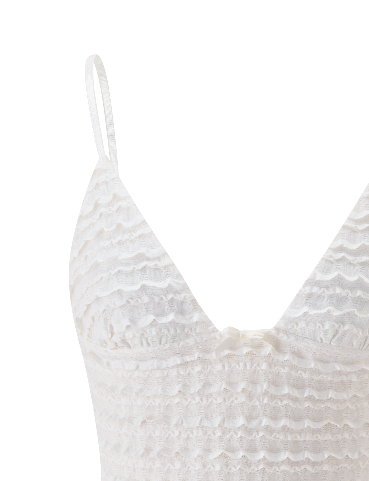 The ZORA TOP - CREAM by TIGERMIST features ruffle detailing, adjustable shoulder straps, and a small bow at the center chest, shown here against a plain white background.