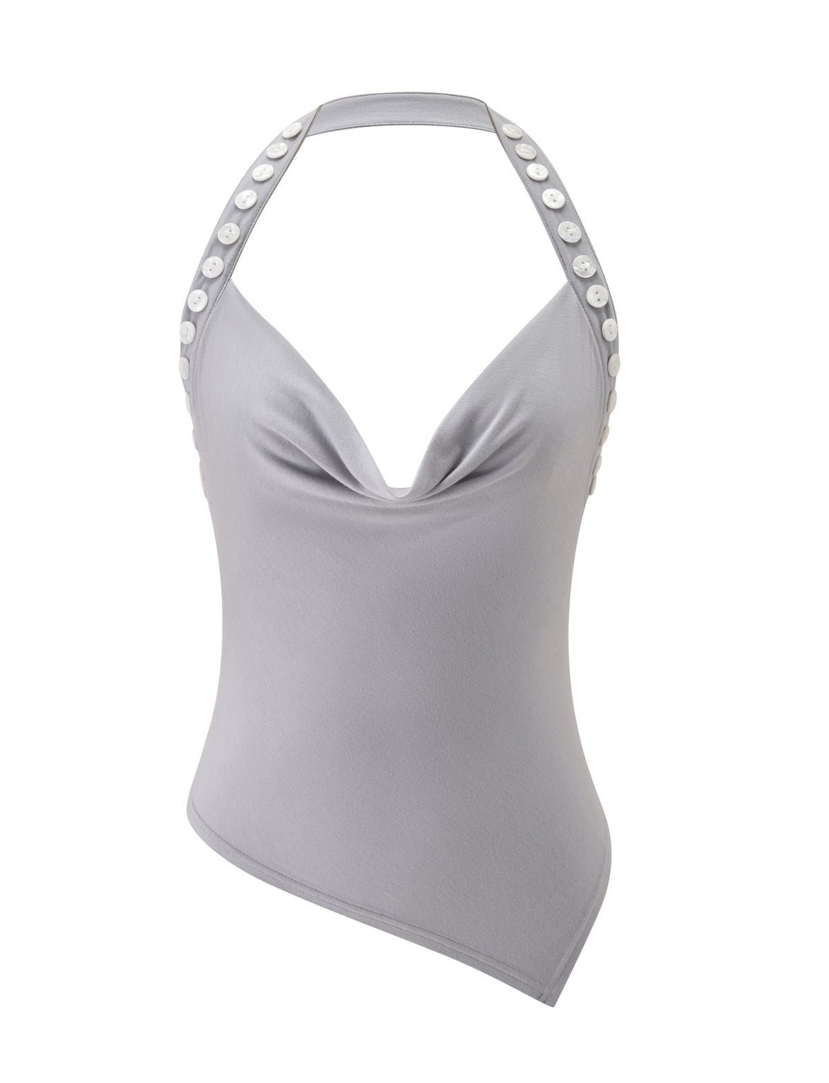 Introducing the SUKI TOP - GREY by TIGERMIST: a light gray cowl neck top showcasing an asymmetrical hem and elegantly draped neckline. The halter strap design is highlighted by a line of white buttons along the shoulders, bringing a distinctive flair to this contemporary piece.