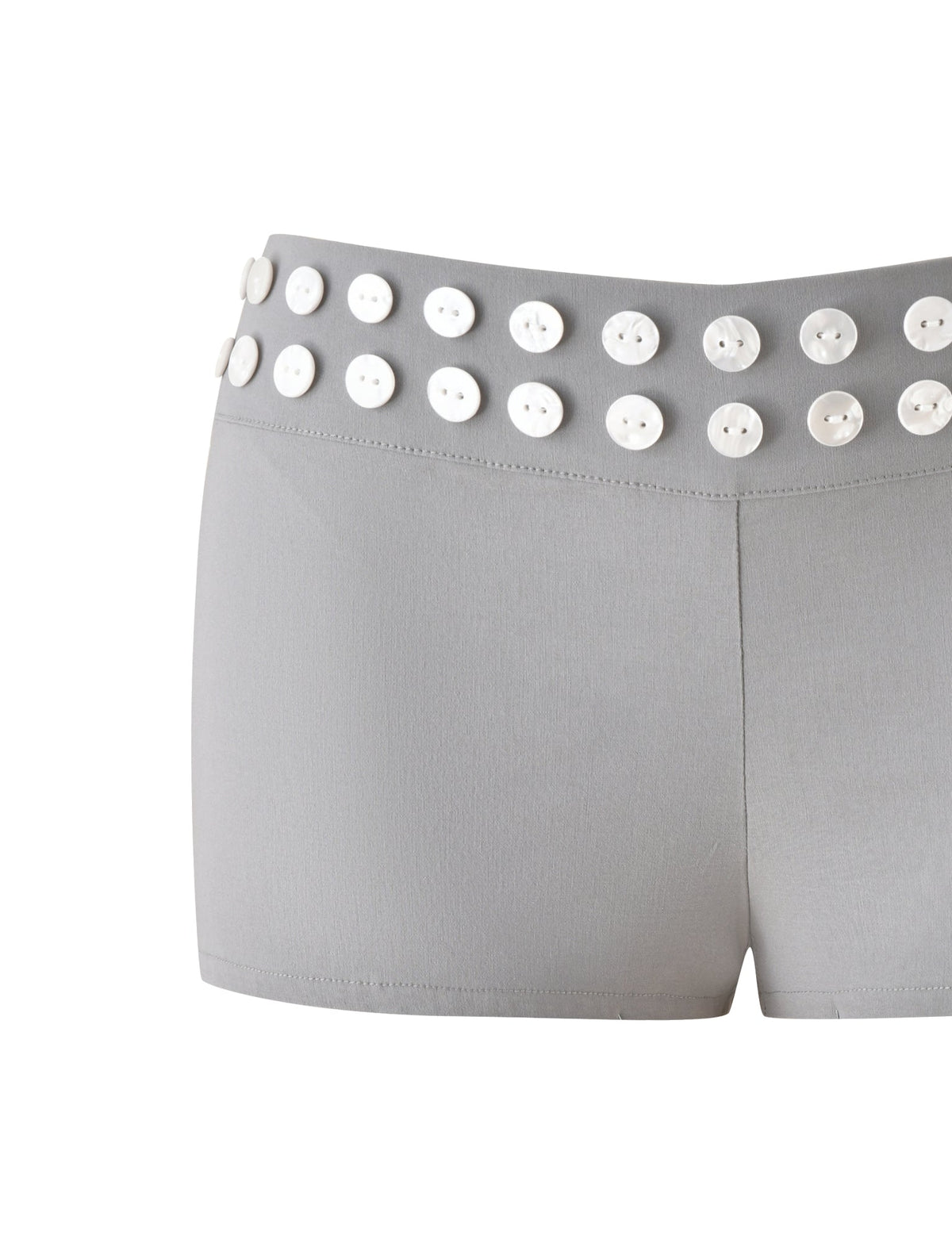 The SUKI SHORT - GREY by TIGERMIST features a tailored silhouette with a fitted style, crafted from smooth-textured fabric. The waistband is accented with two rows of evenly spaced white faux shell buttons for a distinctive touch.