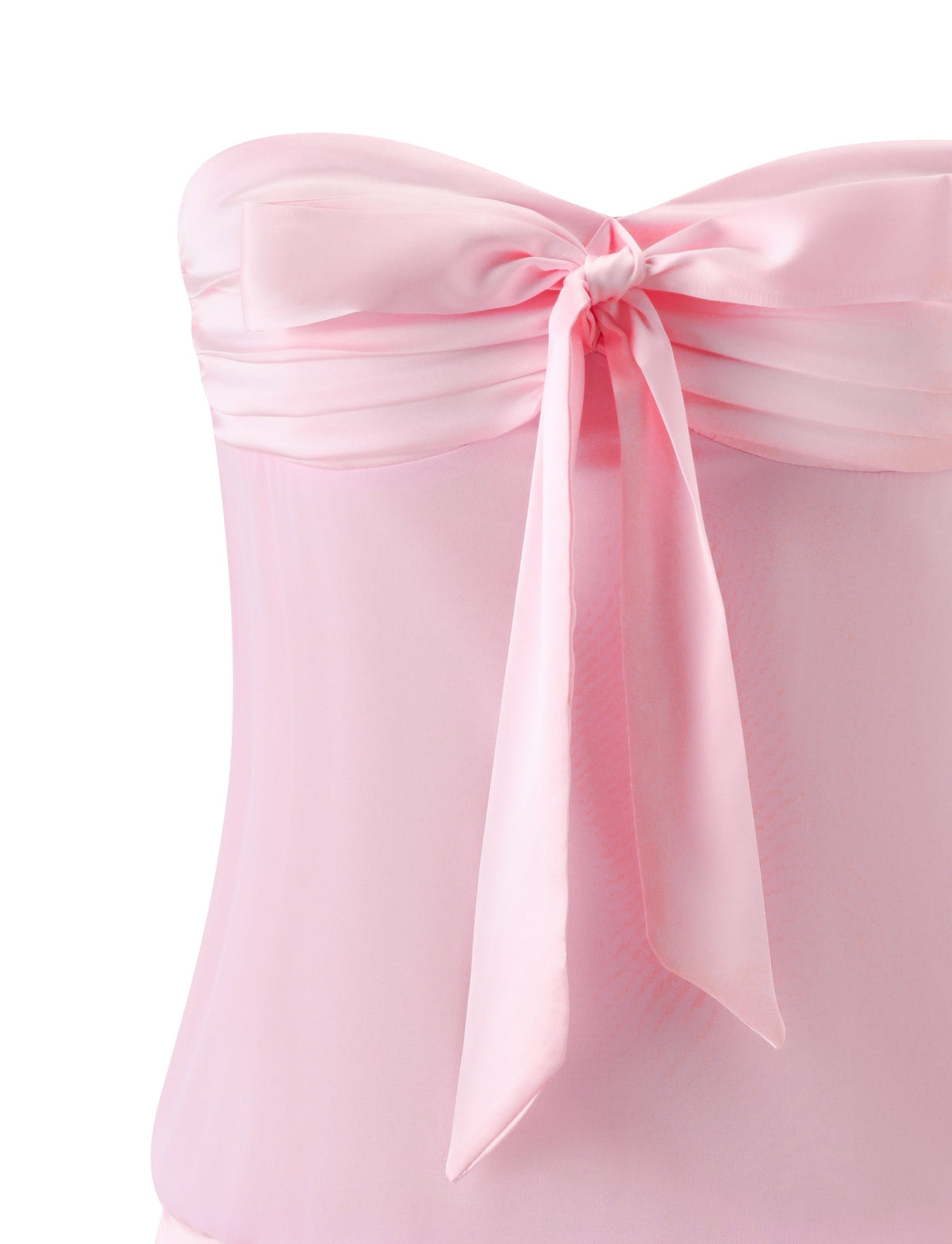 A close-up of the TIGERMIST LUX MINI DRESS - BALLET PINK shows its strapless bodice with a sheer overlay and satin bow—ideal for your next girls’ night out.