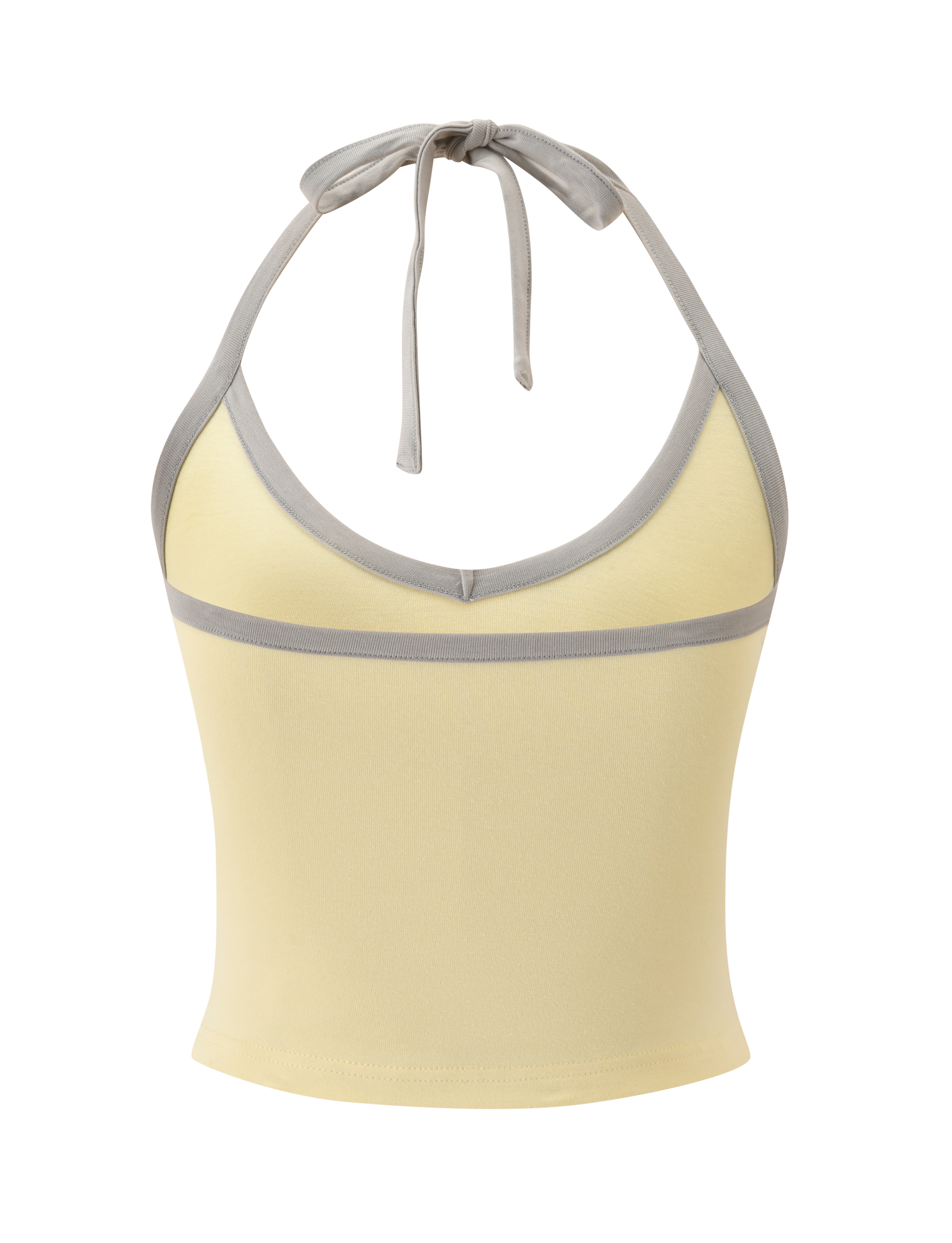 The ALYSIA TOP - BUTTER by TIGERMIST is a sleeveless light yellow halter neck top with a v-neckline, gray contrast binding on the neckline and underbust, and a tie closure at the neck.