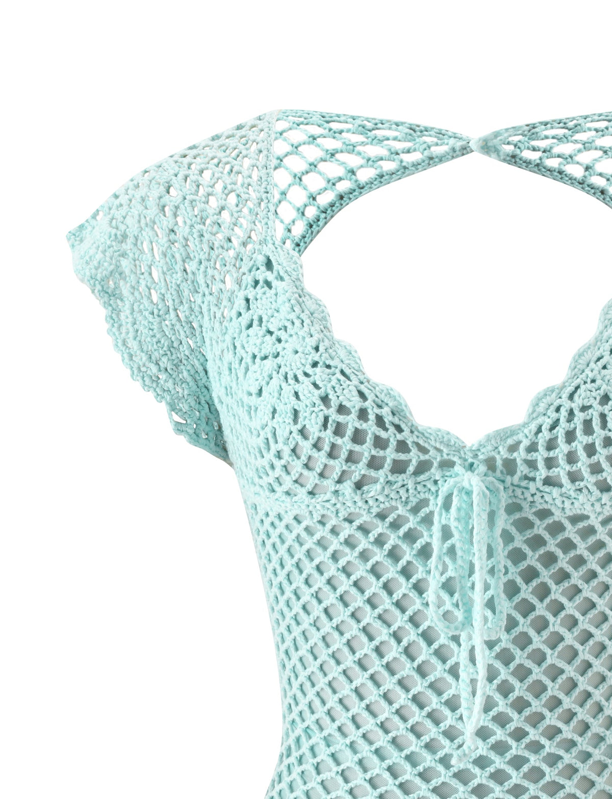 A close-up of the SASHA CROCHET MINI DRESS - MINT by TIGERMIST, featuring short sleeves, a scalloped neckline, and front tie—perfect as a bikini cover-up on a white background.