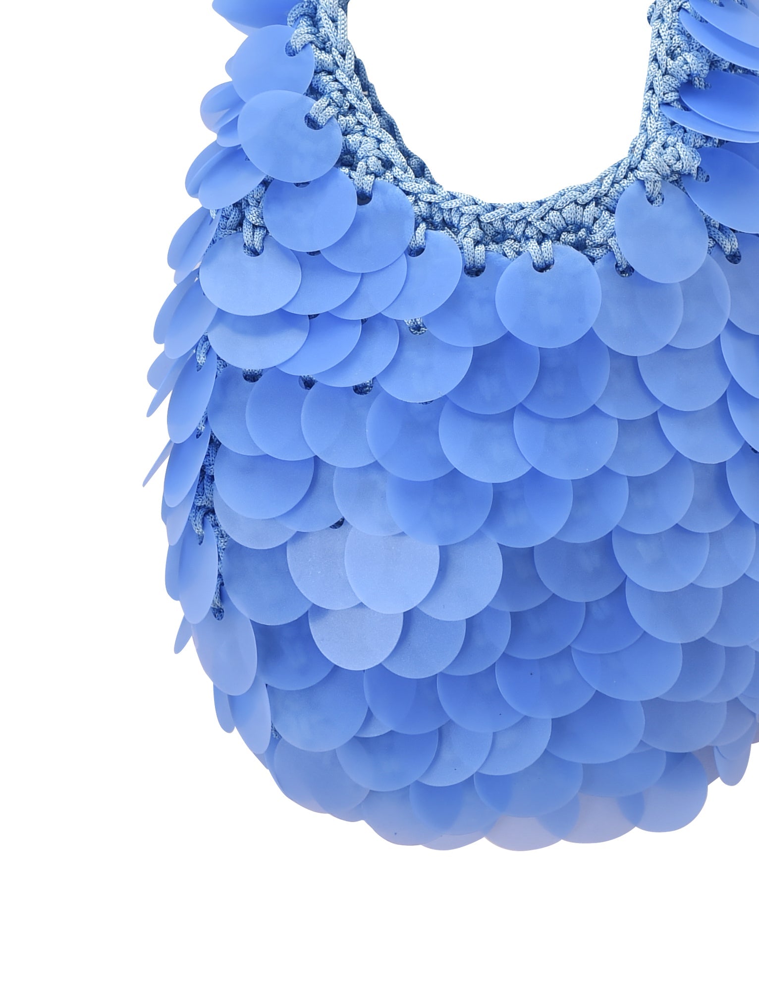 Close-up of the CLEO BAG - BRIGHT BLUE by TIGERMIST, featuring overlapping round blue sequin discs that create a scale-like effect and finished with a woven blue top handle.