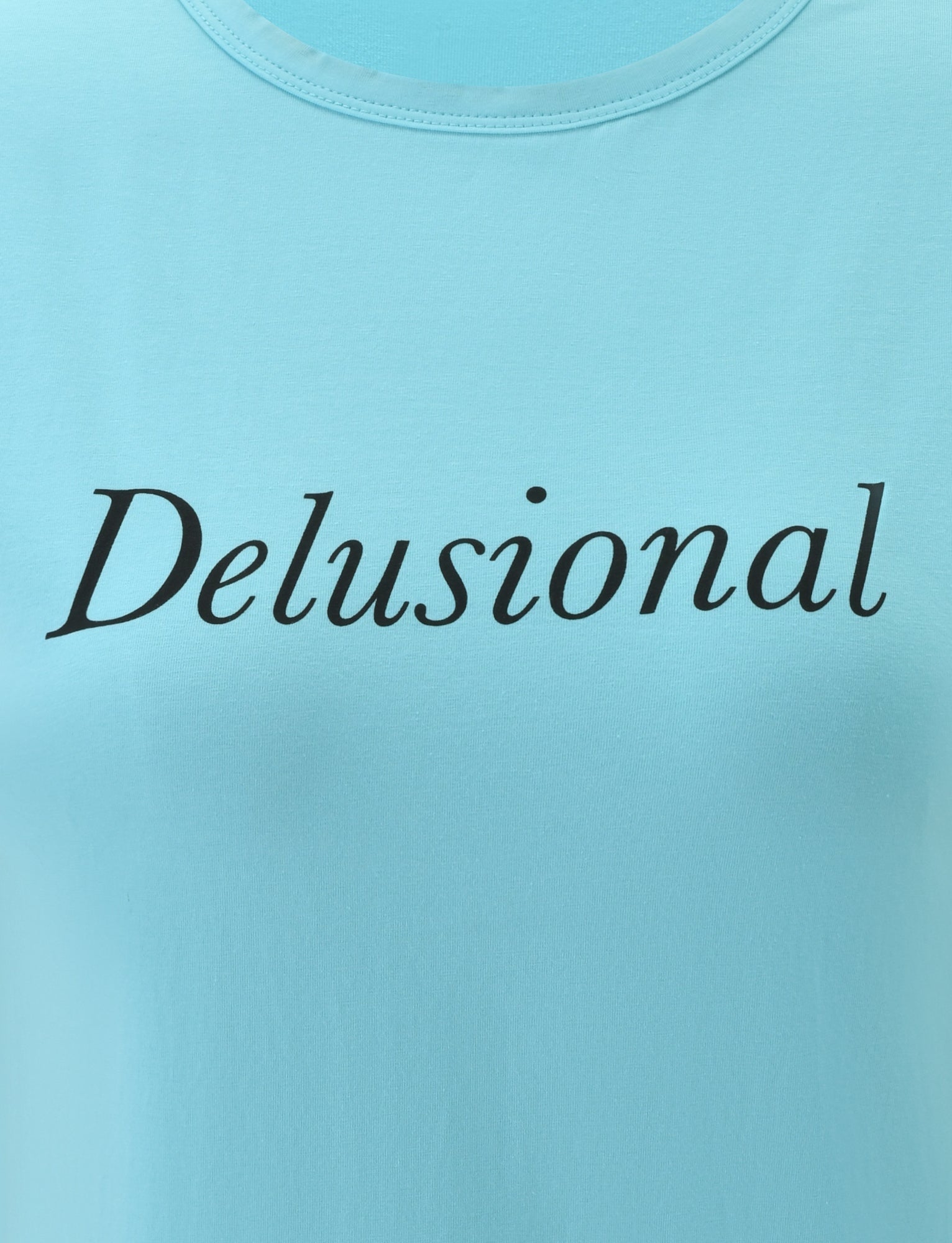The DANIELLE TEE - TURQUOISE by TIGERMIST features the word “Delusional” printed in bold black italic font across the chest. This turquoise blue graphic tee offers a playful twist to your everyday look with its vintage boxy silhouette, delivering an effortlessly cool vibe and comfortable fit.