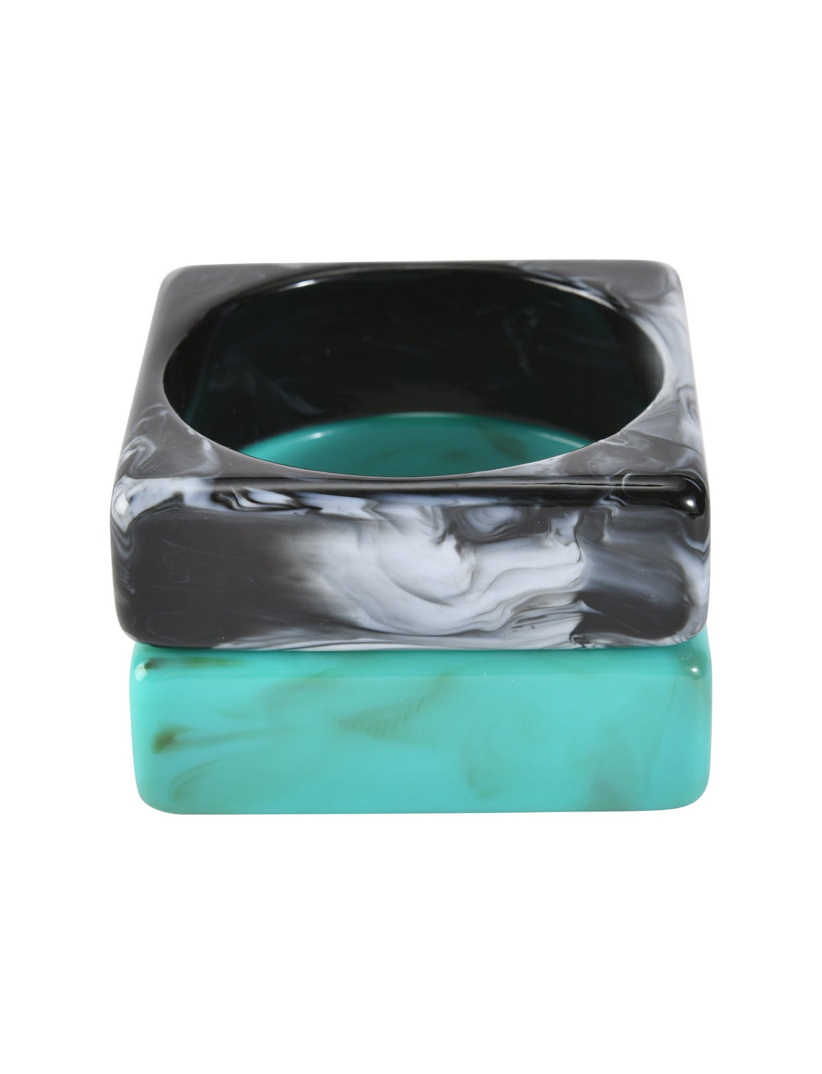 The AUGIE BANGLE SET - EMERALD AND BLACK by TIGERMIST features two square, chunky bangles—one with a black marble effect and one solid emerald—stacked together, both with smooth rounded edges on a white background.