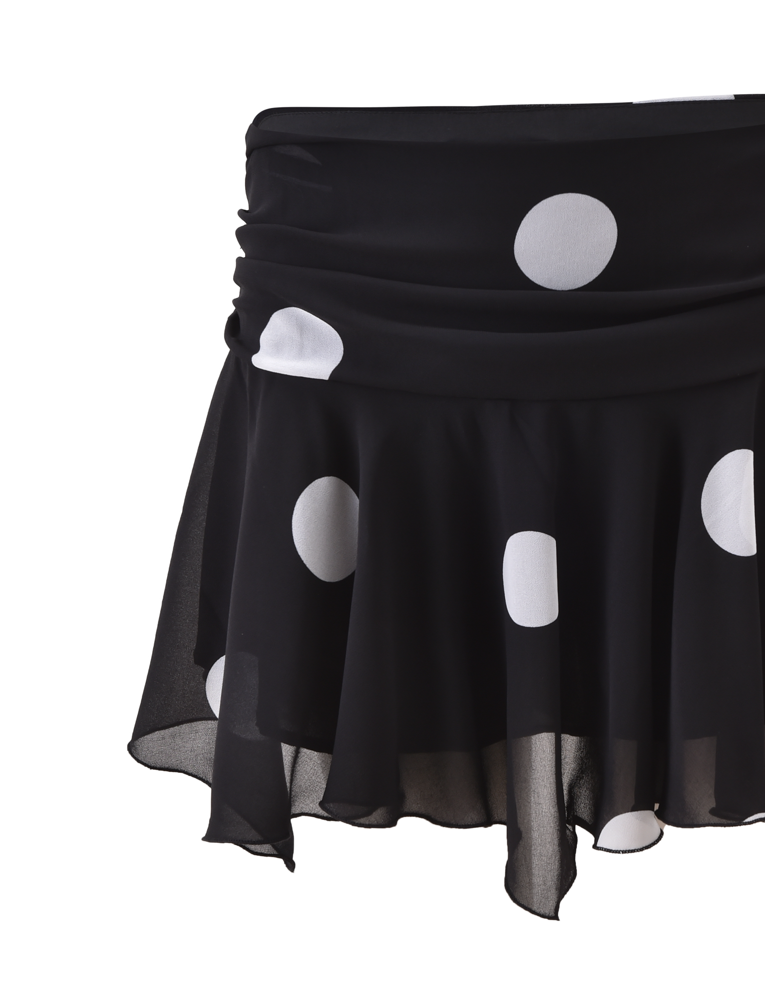 The AYDIN MINI SKIRT by TIGERMIST is a black, flowy skirt with large white polka dots, a sheer overlay, ruched waistband, and asymmetrical hem, displayed against a plain white background.