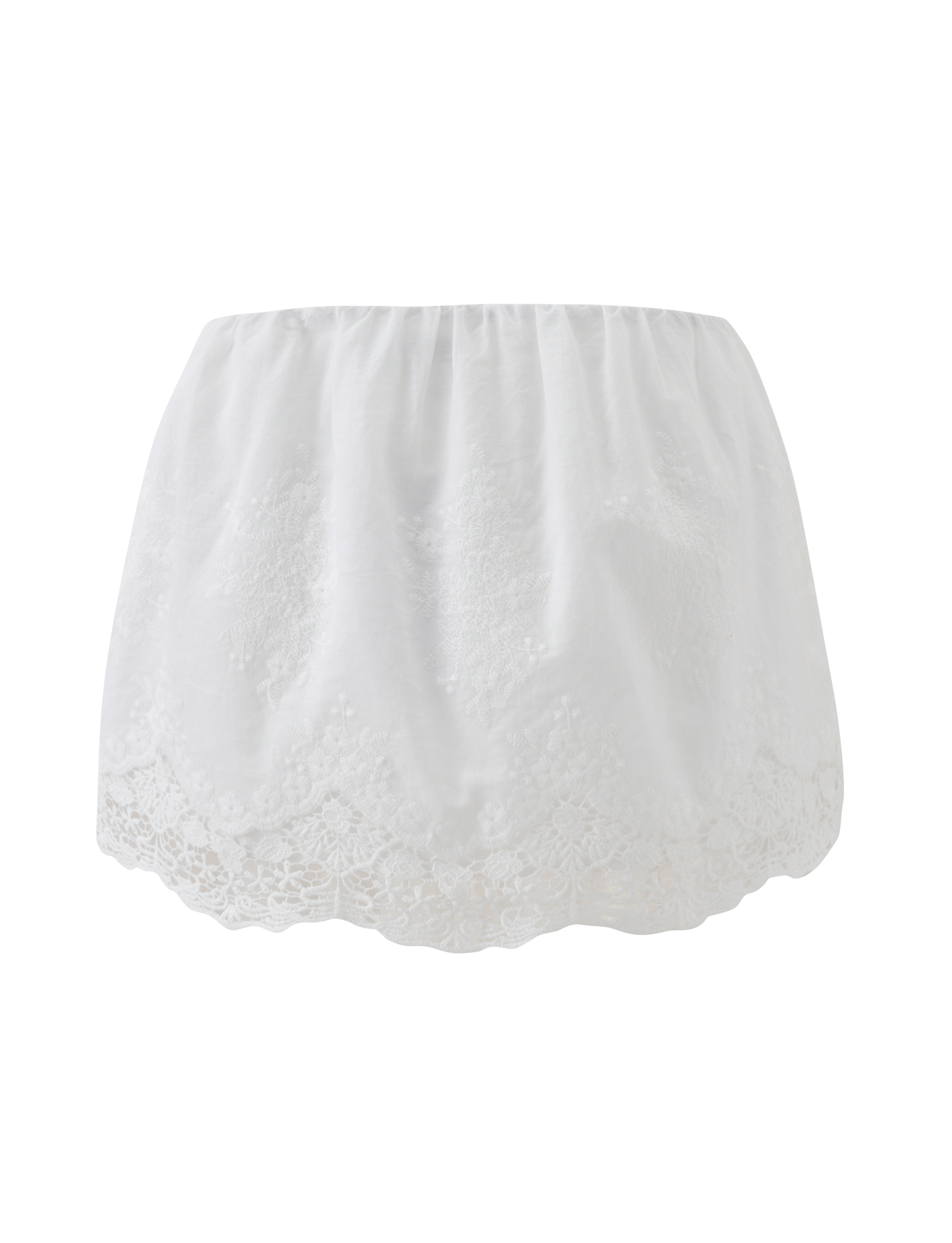 The CAILEIGH MINI SKIRT - WHITE by TIGERMIST features lace detailing, a scalloped hem, and floral embroidery, shown against a plain white background.