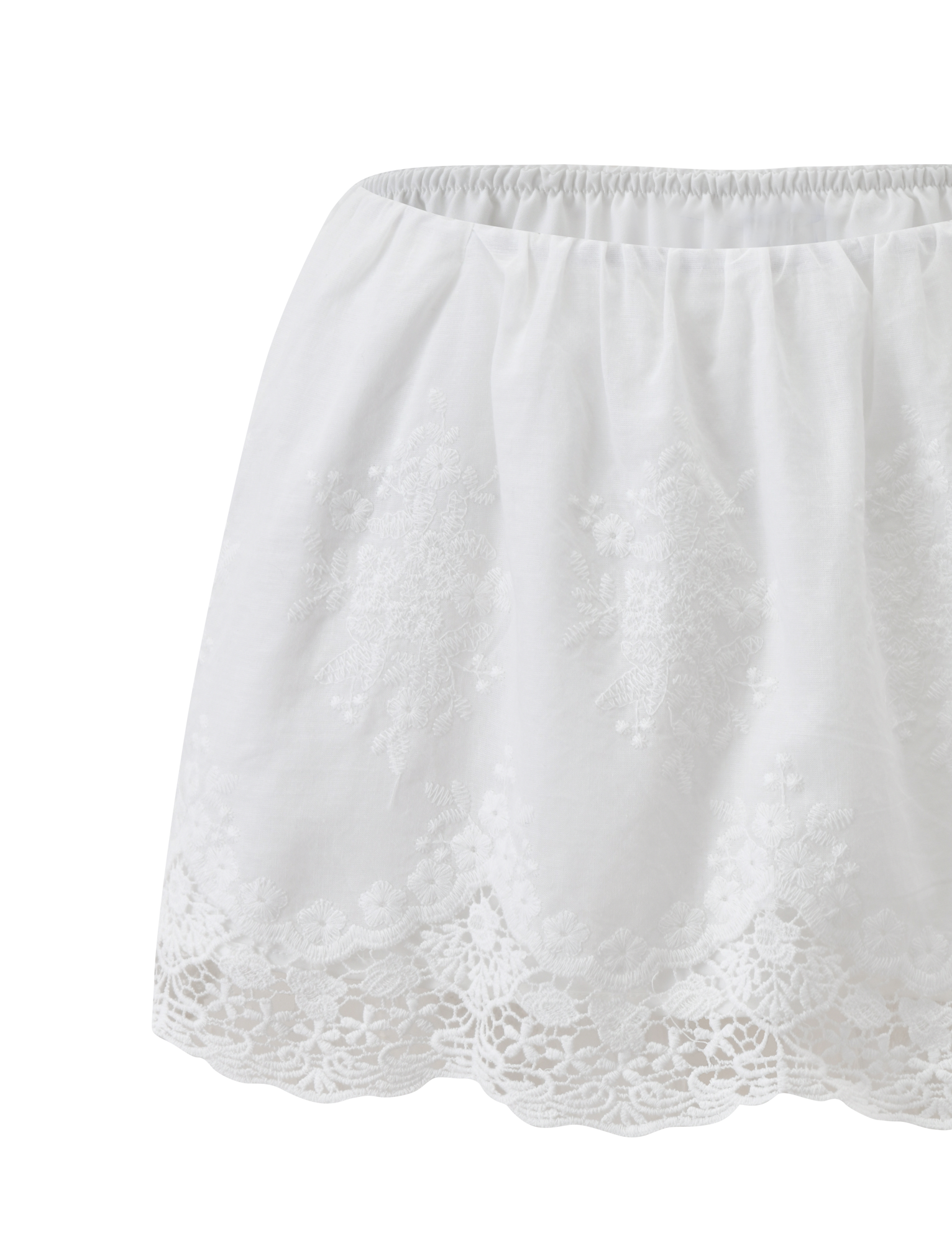 The CAILEIGH MINI SKIRT in white by TIGERMIST features an elastic waistband, delicate lace details, scalloped hem, feminine A-line fit, and intricate embroidery for a light, airy look.